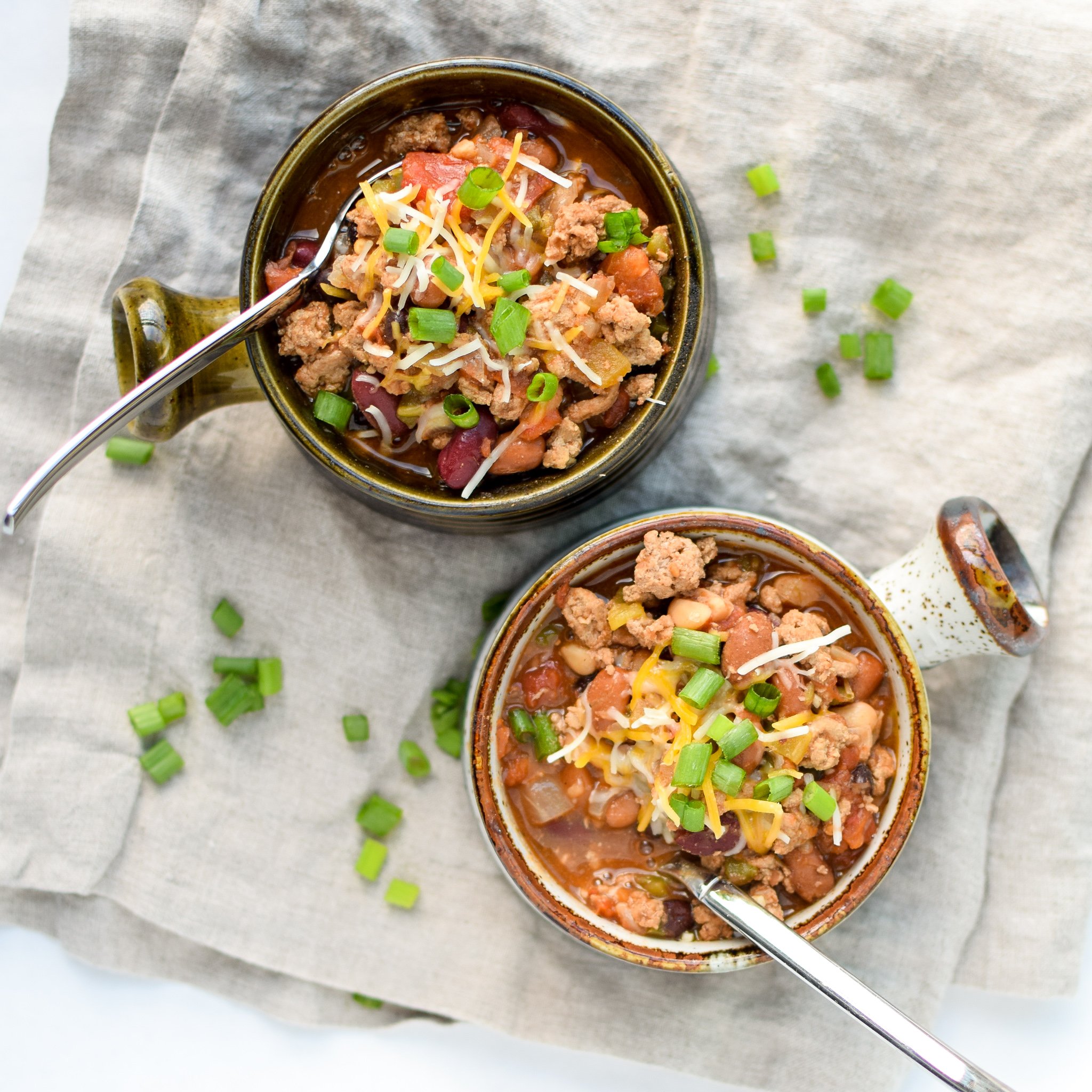 Easy Slow Cooker 4-Bean Turkey Chili recipe - A slow cooker classic that should be in everyone's cookbook! A hearty bean and turkey chili with some smokey kick! - ProjectMealPlan.com