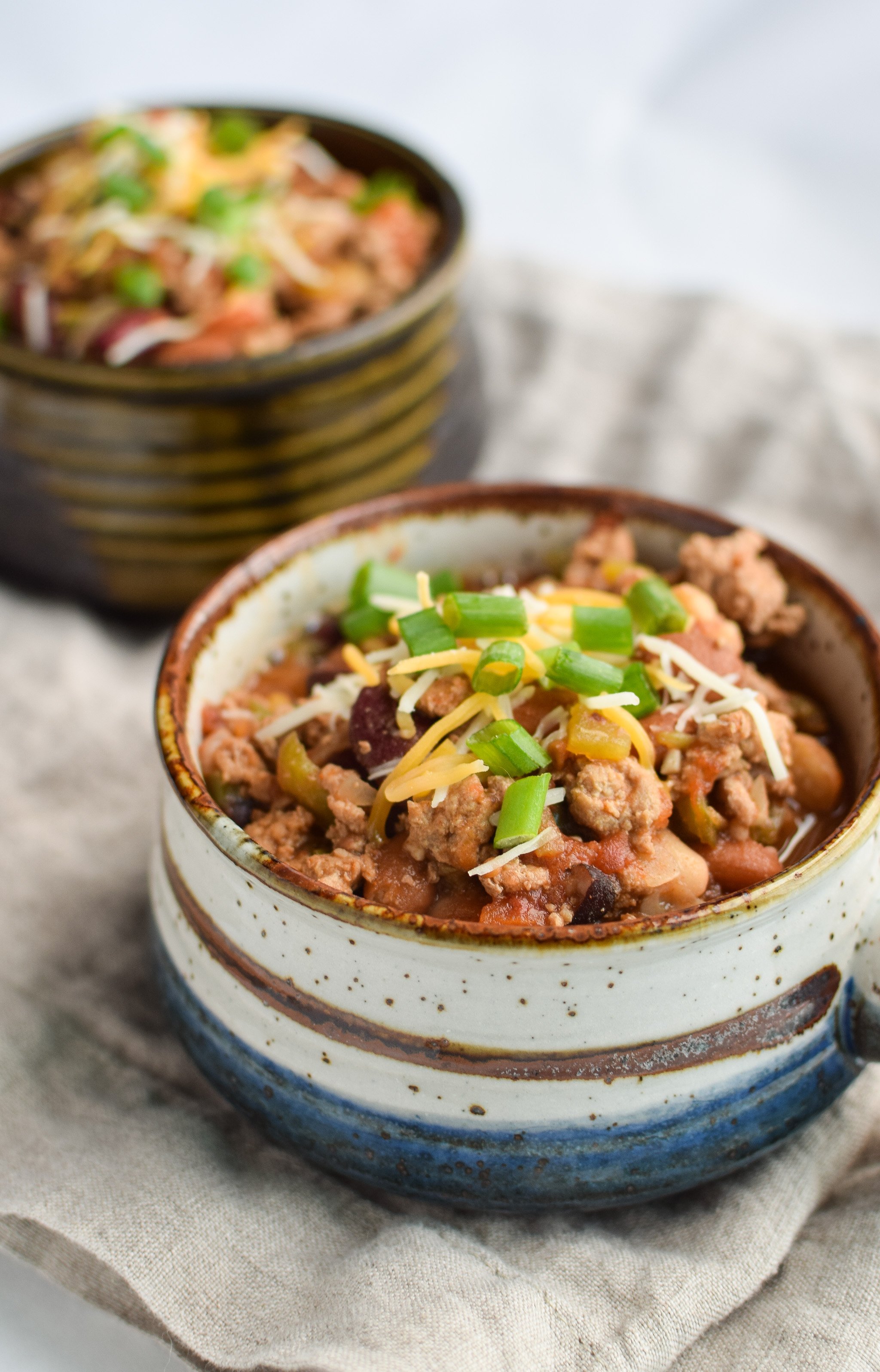 Easy Slow Cooker 4-Bean Turkey Chili recipe - A slow cooker classic that should be in everyone's cookbook! A hearty bean and turkey chili with some smokey kick! - ProjectMealPlan.com