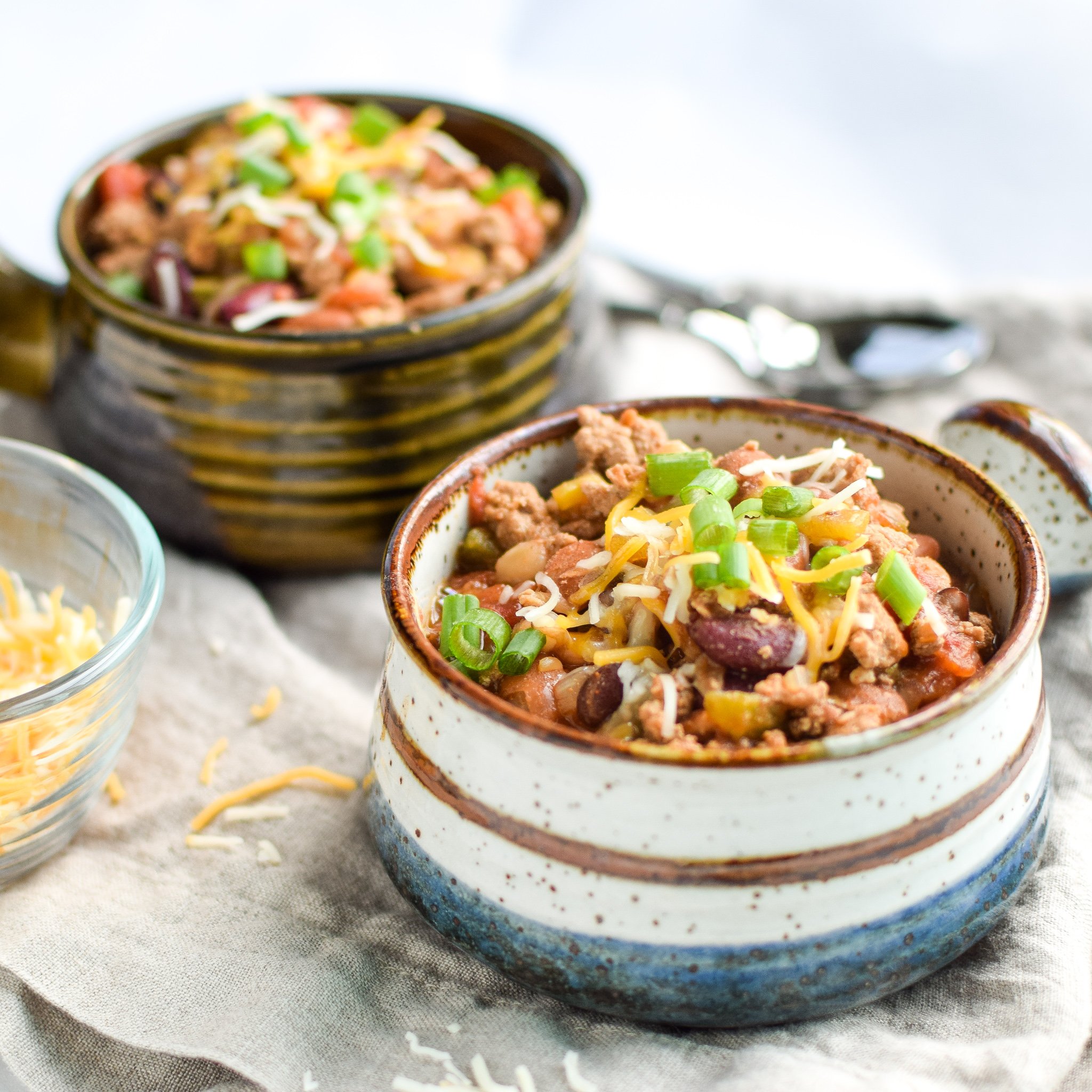 Easy Slow Cooker 4-Bean Turkey Chili recipe - A slow cooker classic that should be in everyone's cookbook! A hearty bean and turkey chili with some smokey kick! - ProjectMealPlan.com