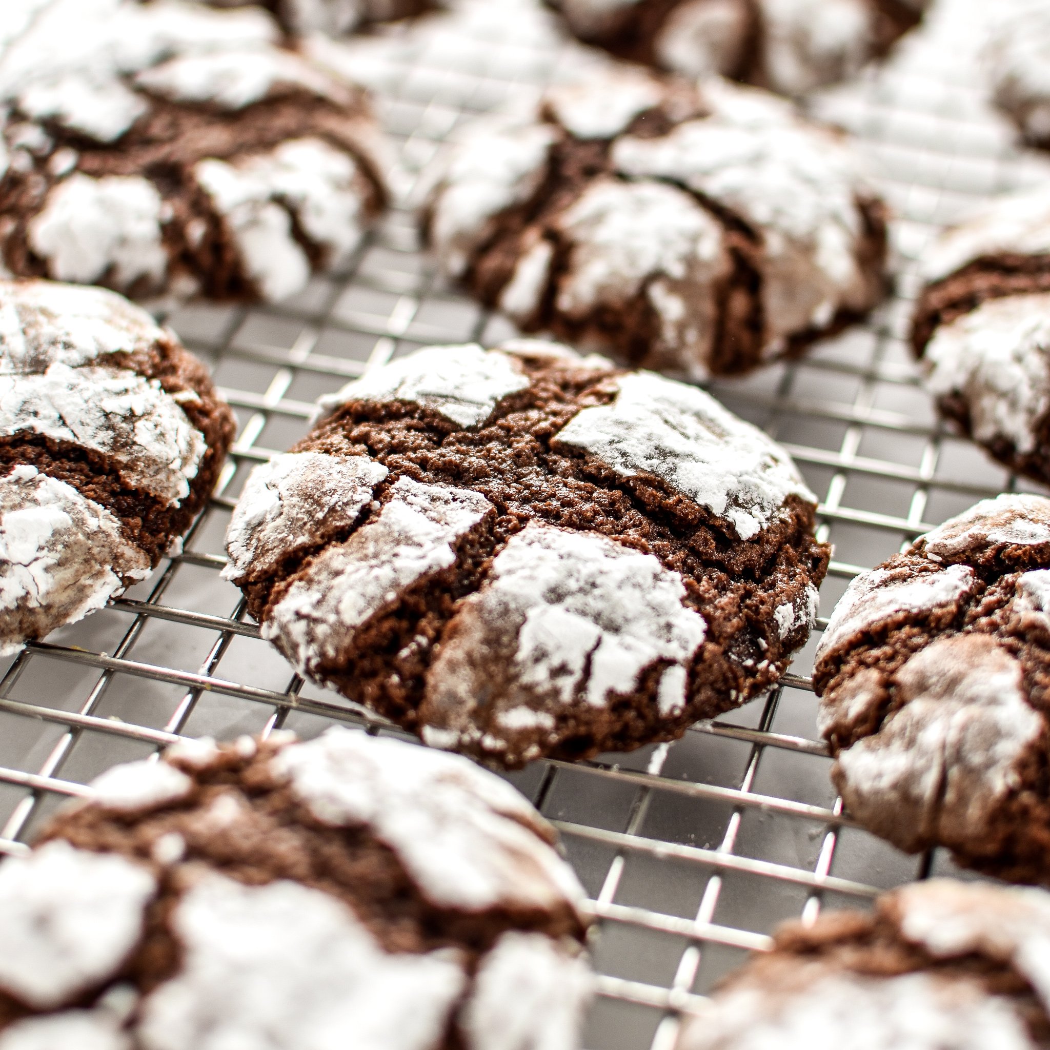 Classic Chewy Chocolate Crinkle Cookies on a cooling rack.