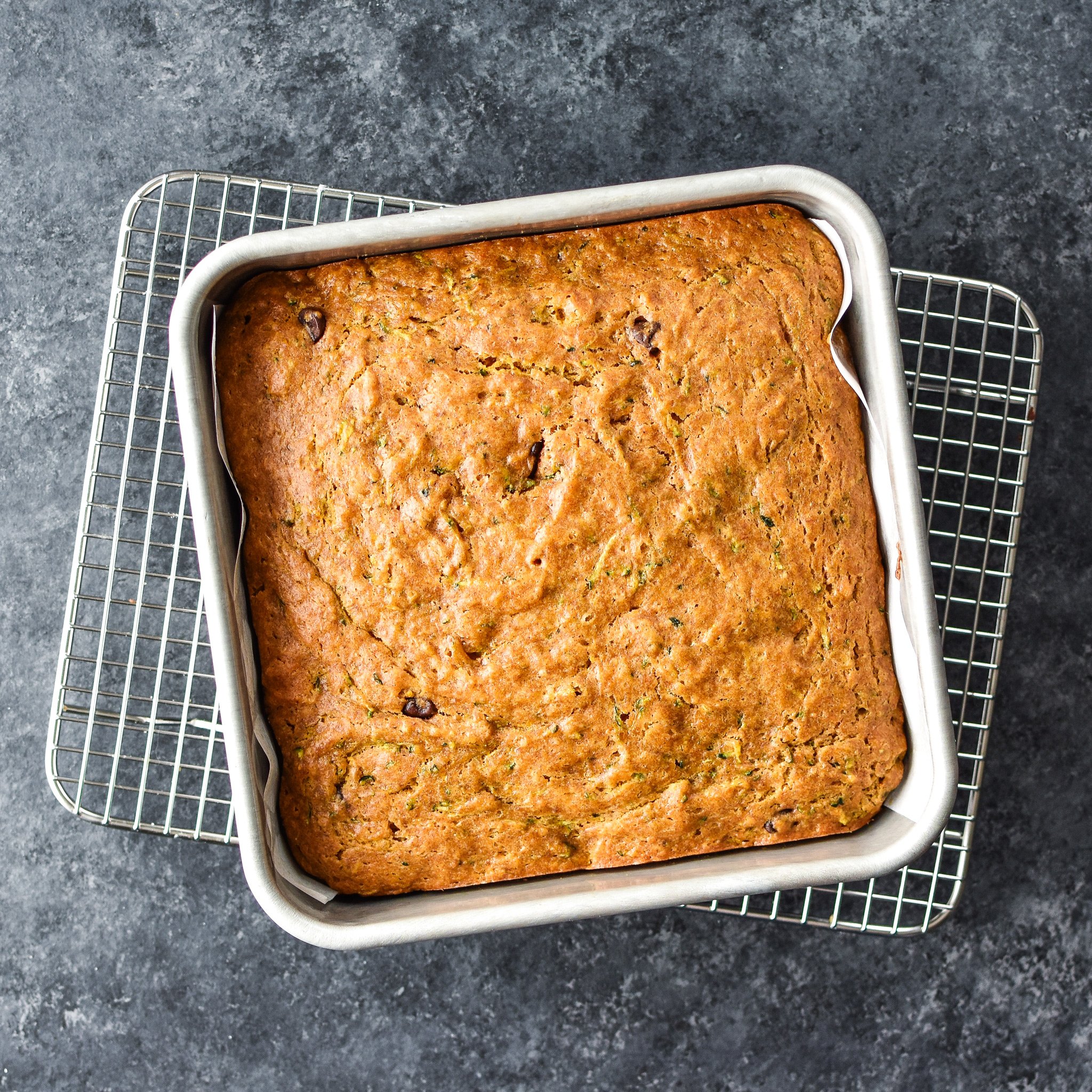 Cooked zucchini bread on a cooling rack.