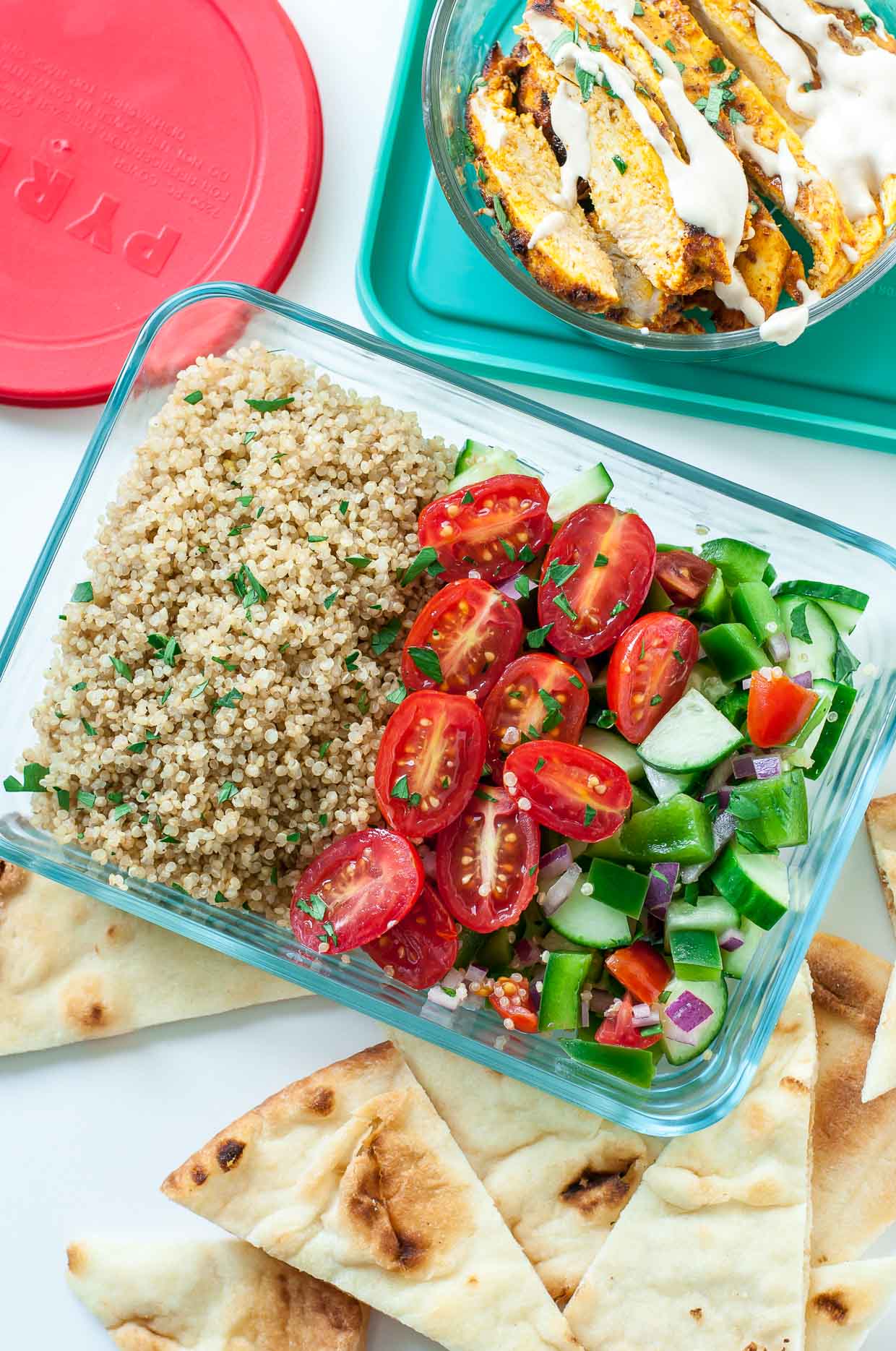 Quinoa, fresh veggies and chicken shawarma meal prepped in Pyrex containers.