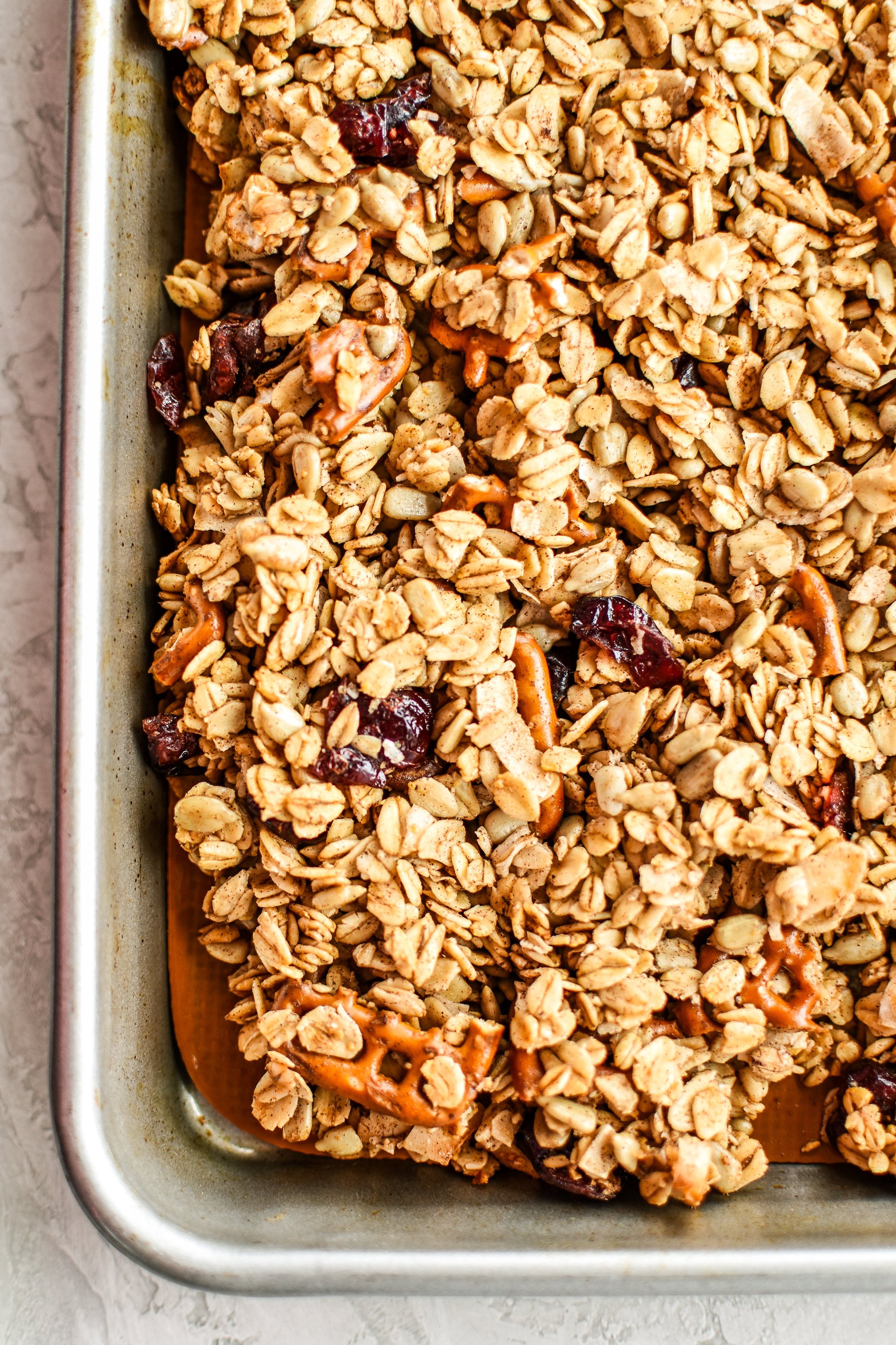 A sheet pan with cooked granola cooling.