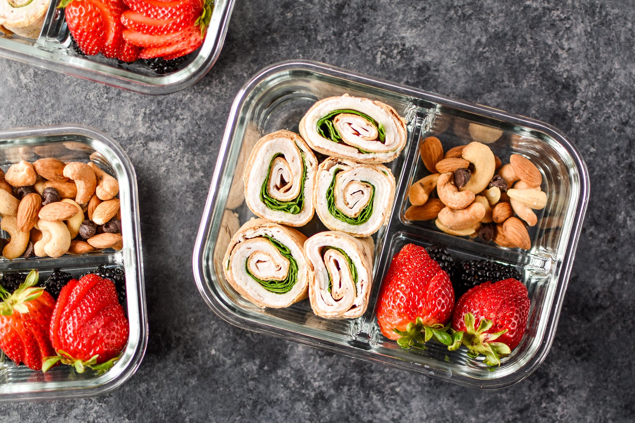 A view of the Easy Turkey Pinwheel Meal Prep from above with berries and nuts.