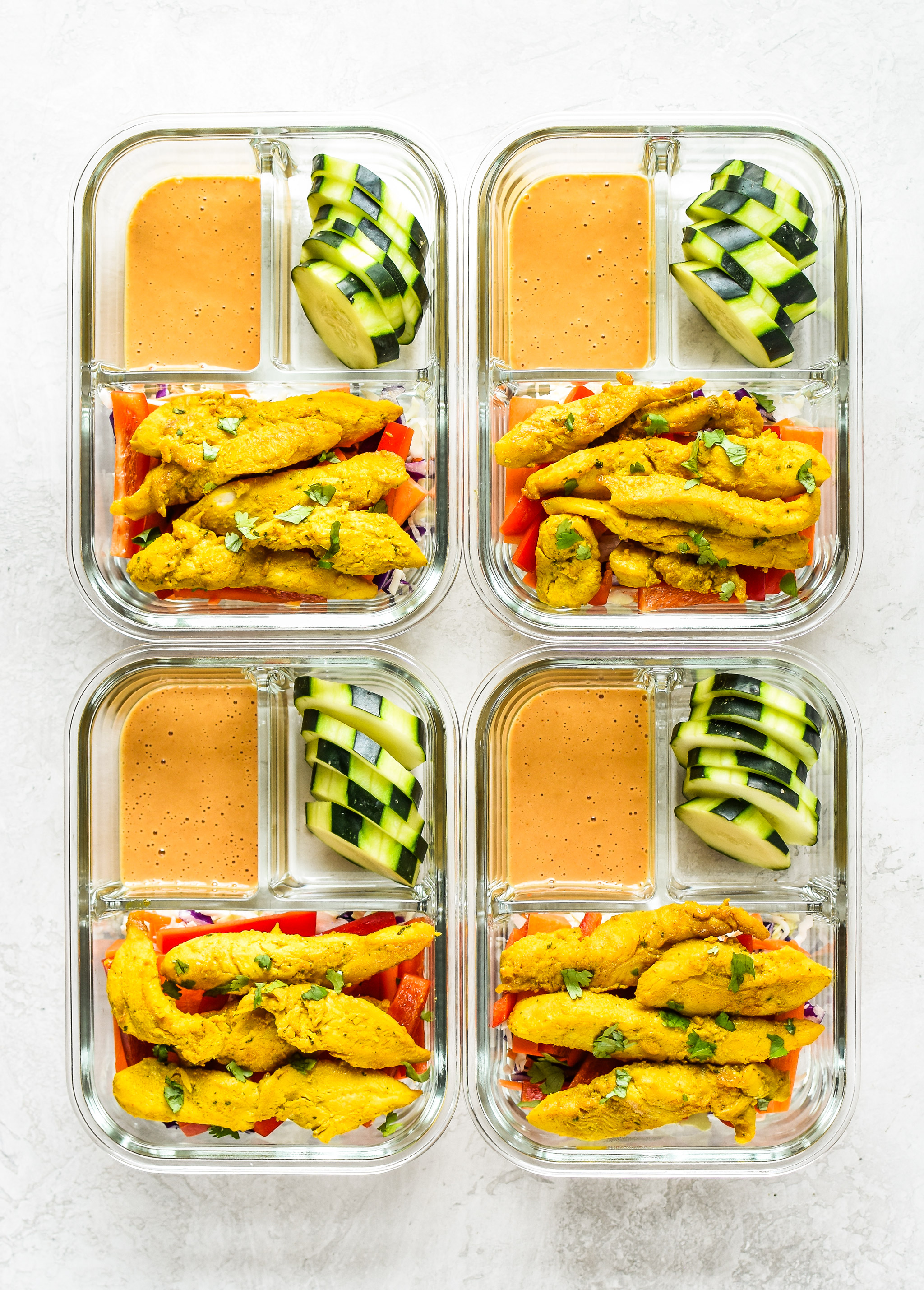 Meal Prep Satay Inspired Thai Chicken Salad Bowls portioned into meal prep containers, viewed from above.