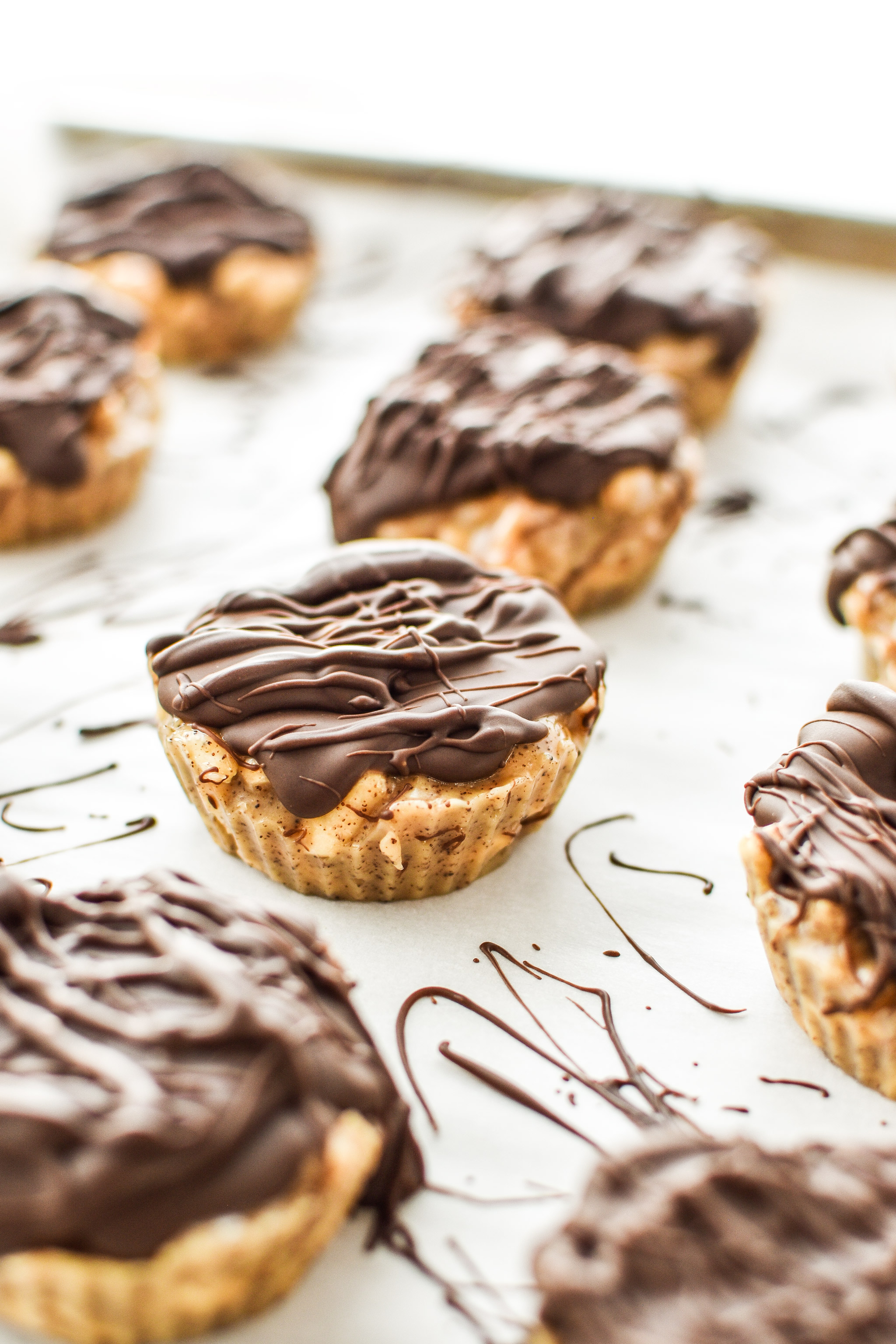 Espresso Crunch Cashew Butter Cups with chocolate drizzled on top.