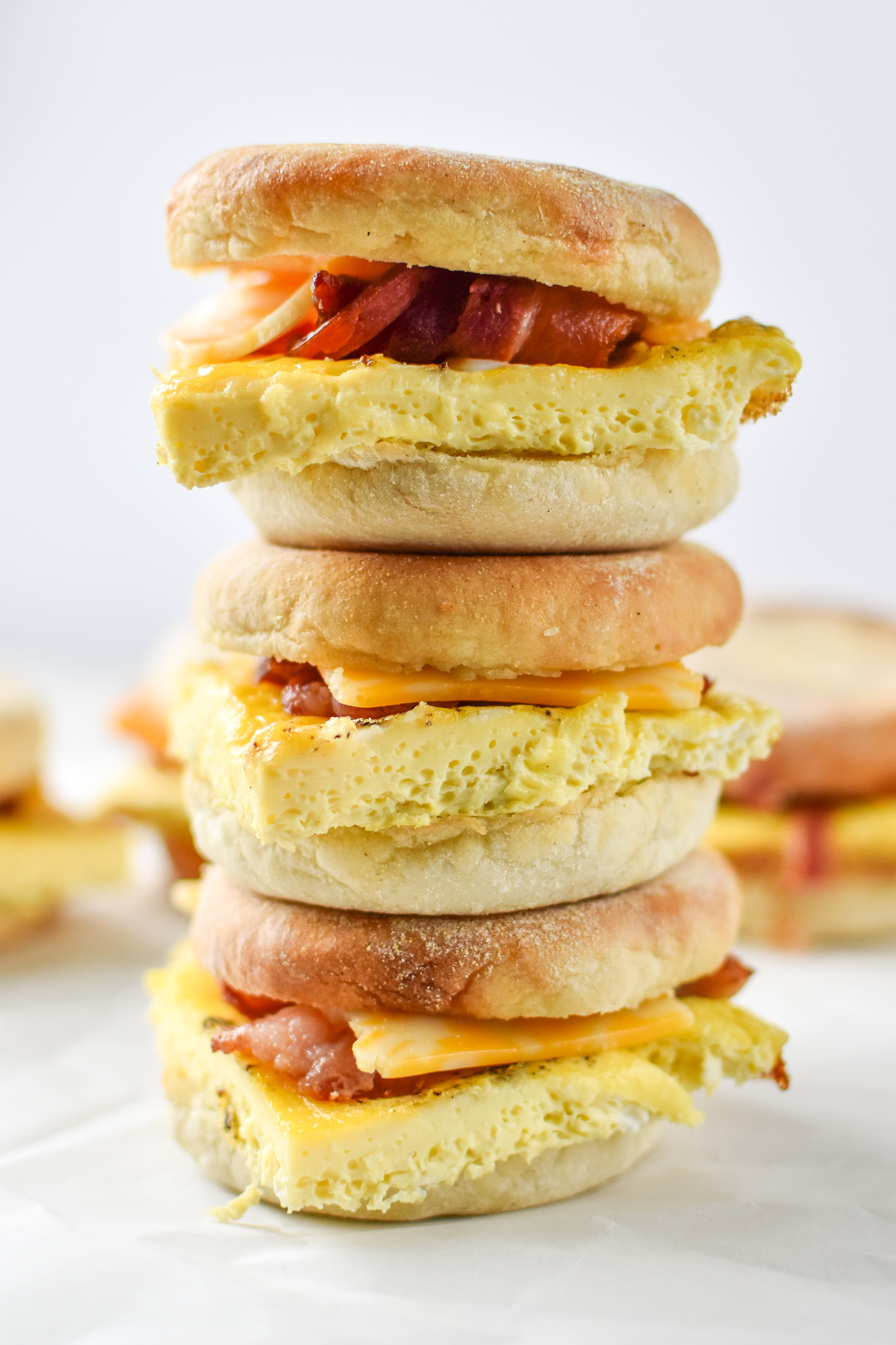 Delicious make-ahead bacon breakfast sandwiches stacked on top of each other