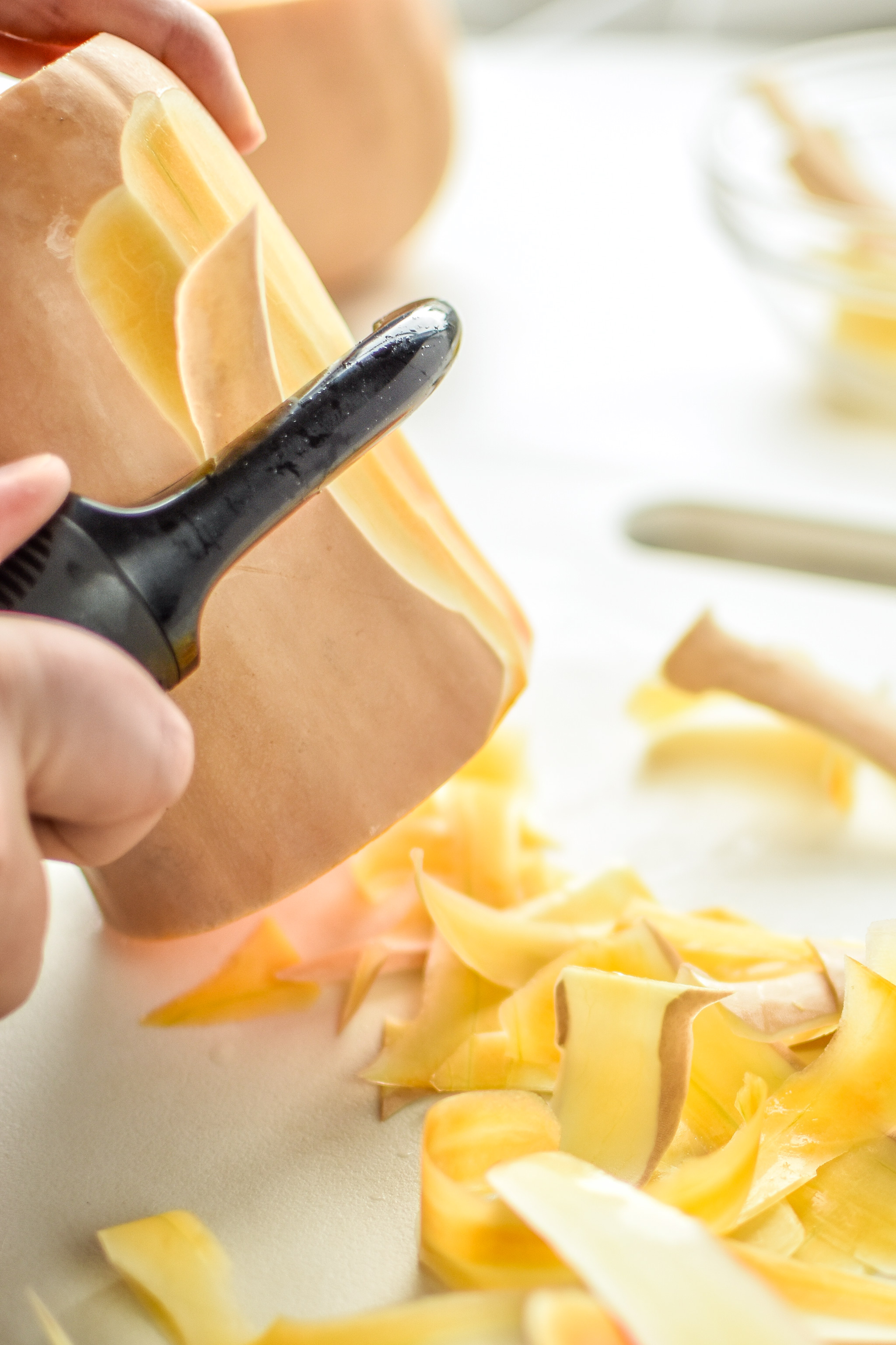 Peeling a butternut squash with the OXO peeler for the Radicchio and Roasted Squash Salad