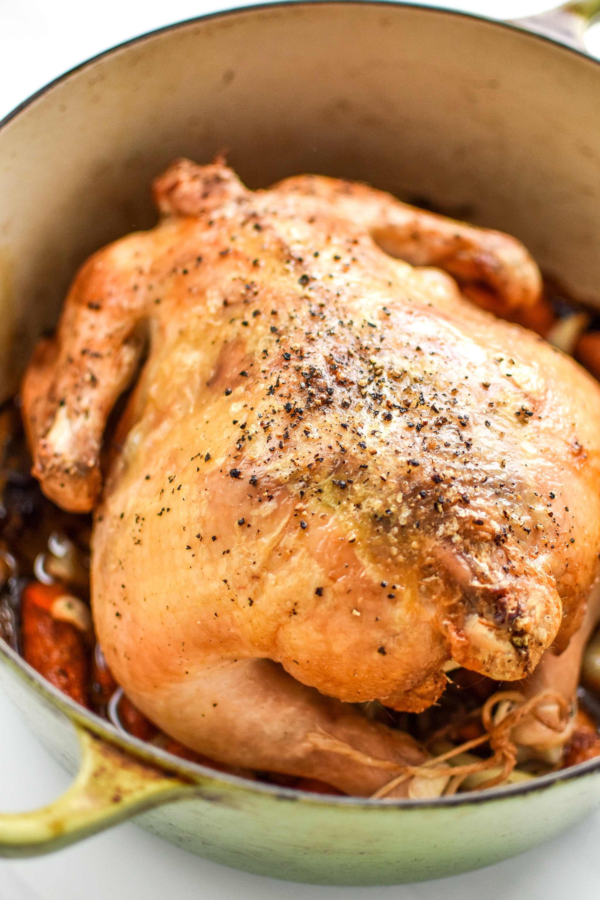A simple whole roast chicken cooked in a Dutch oven.