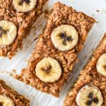peanut butter banana oatmeal breakfast bars with sliced bananas on top.