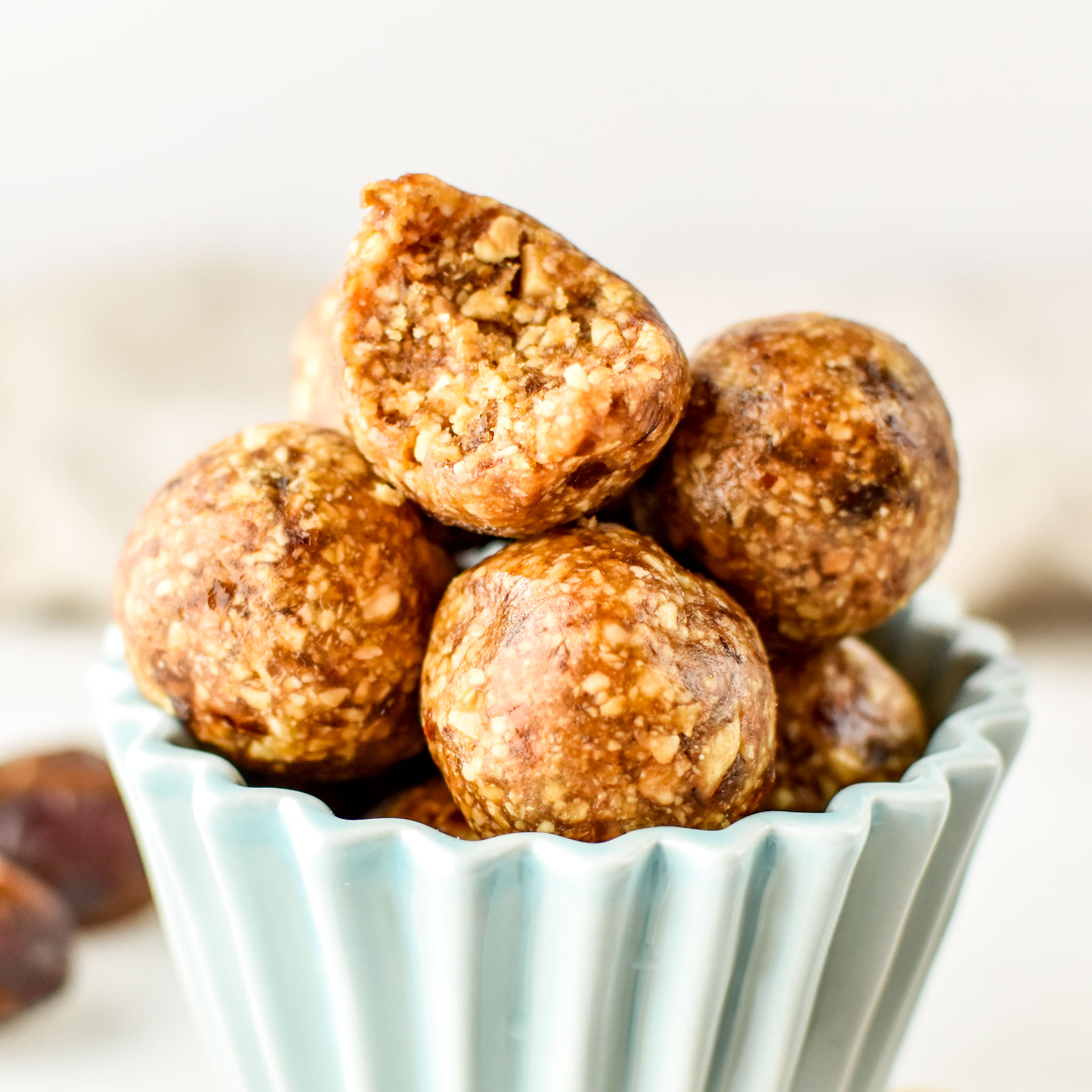 Peanut butter cookie balls on display - top one with a bite taken out.