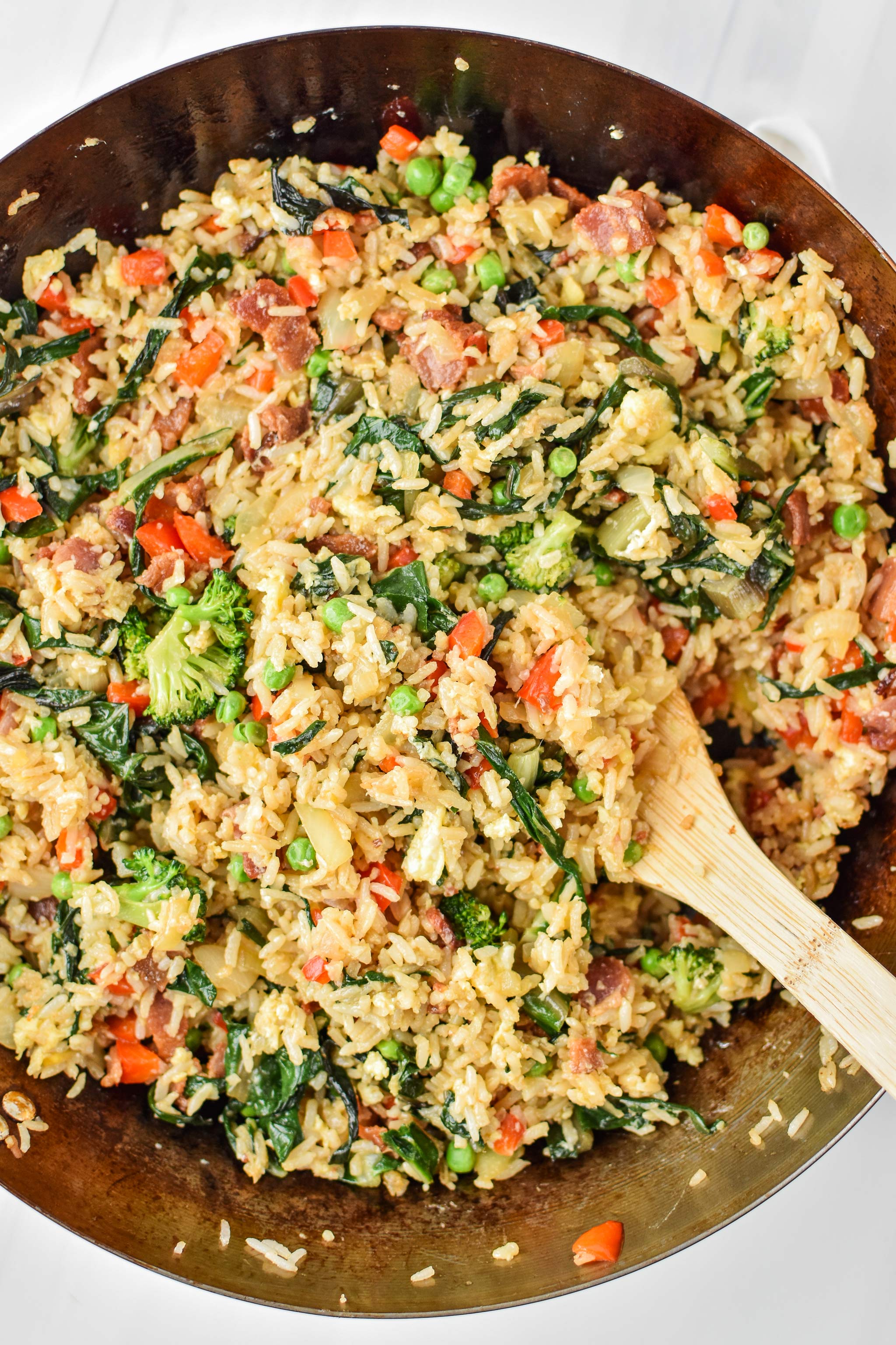 Cooked veggie packed breakfast fried rice in a wok