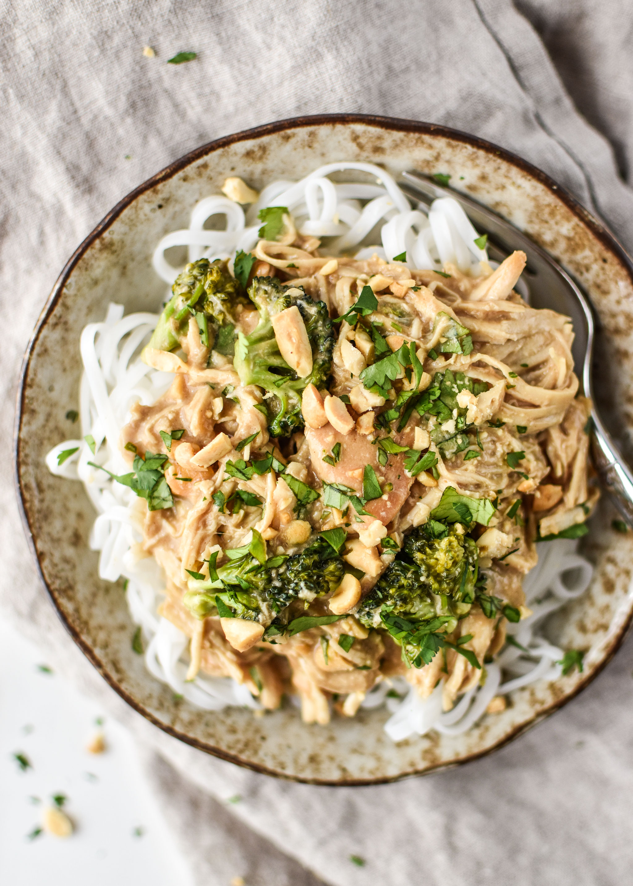 Slow cooker peanut chicken meal prep for lunch served with pad thai rice noodles