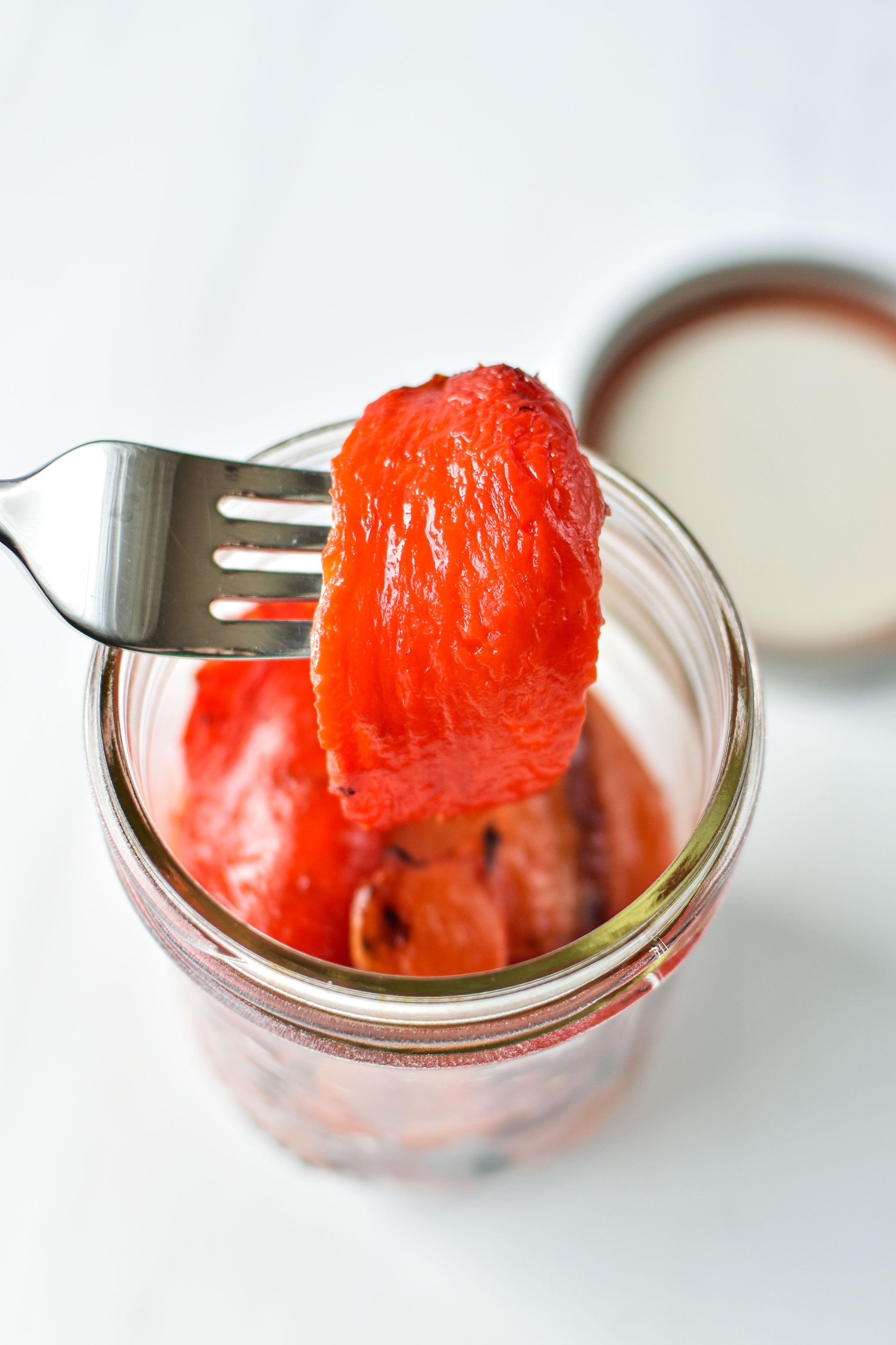 homemade roasted red bell peppers in a jar