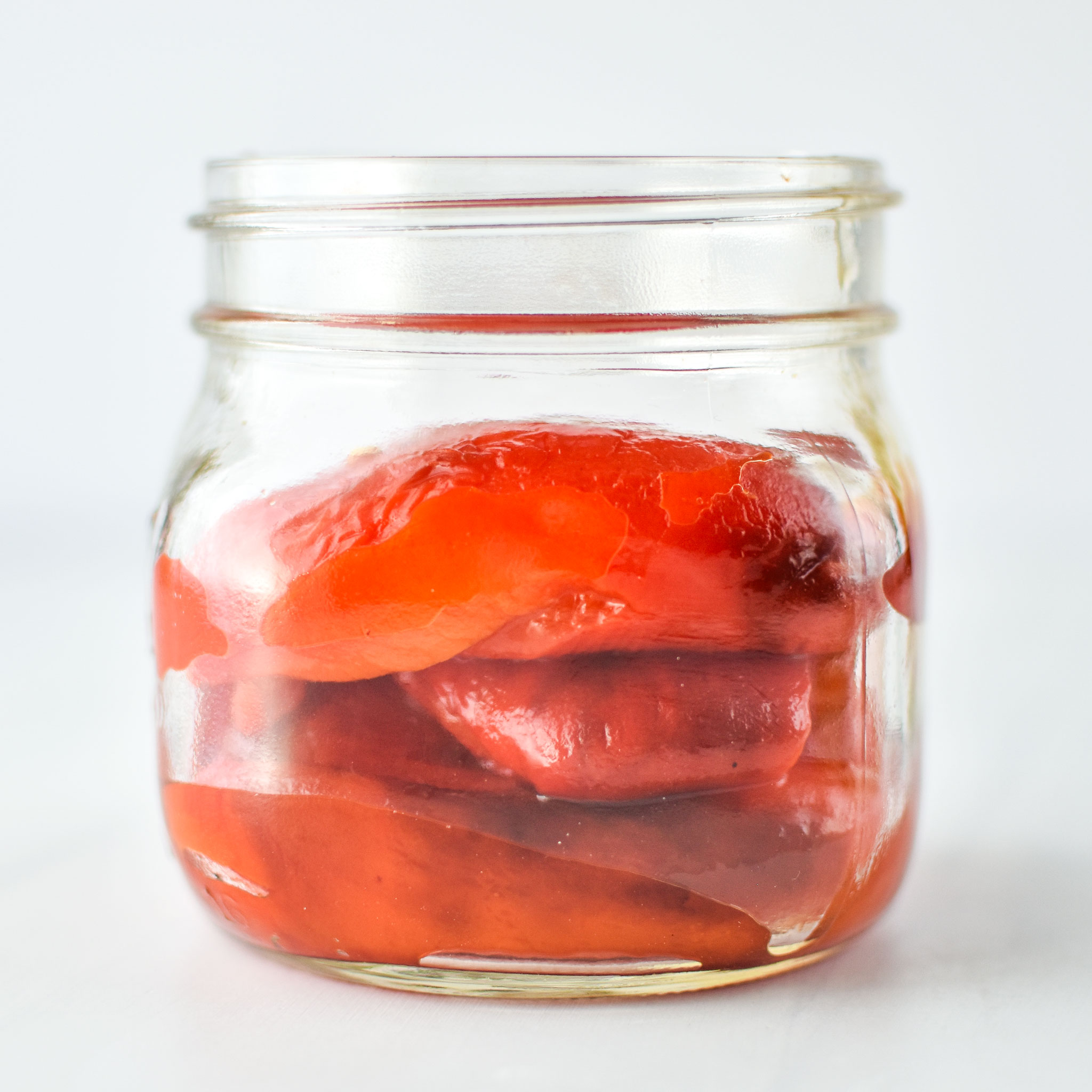 homemade roasted red peppers in a jar