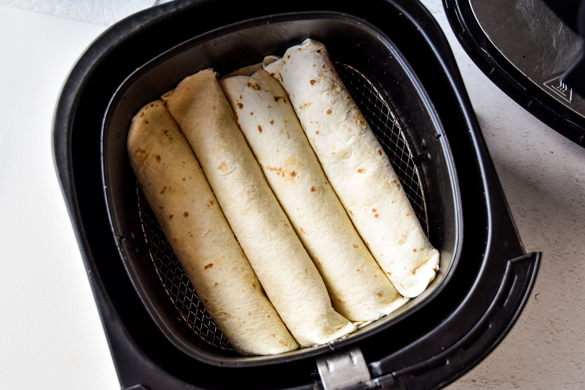 air fryer chicken taquitos ready to be cooked in the air fryer