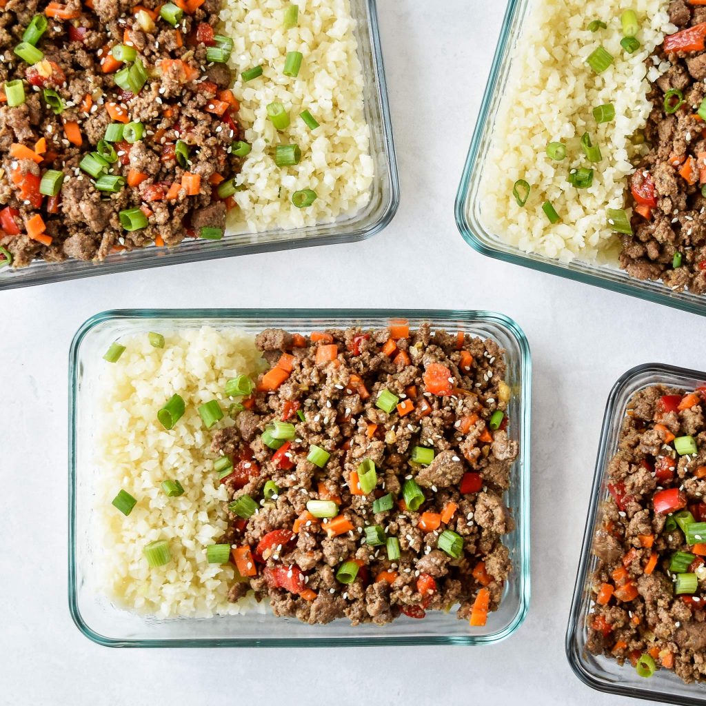 ginger ground beef and cauliflower rice in a glass meal prep bowl.