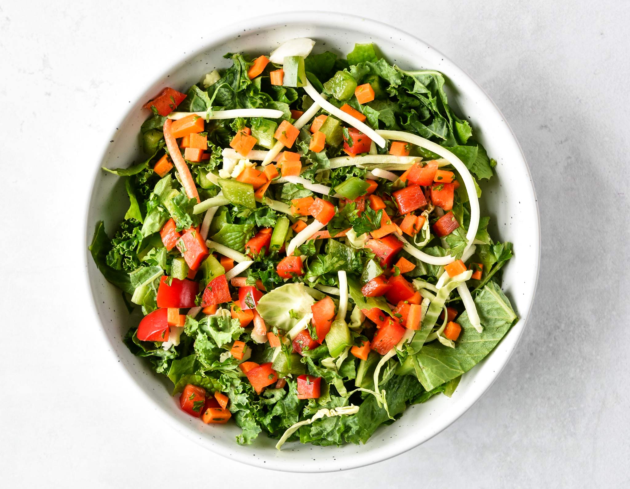 kale salad with vegetable confetti on top