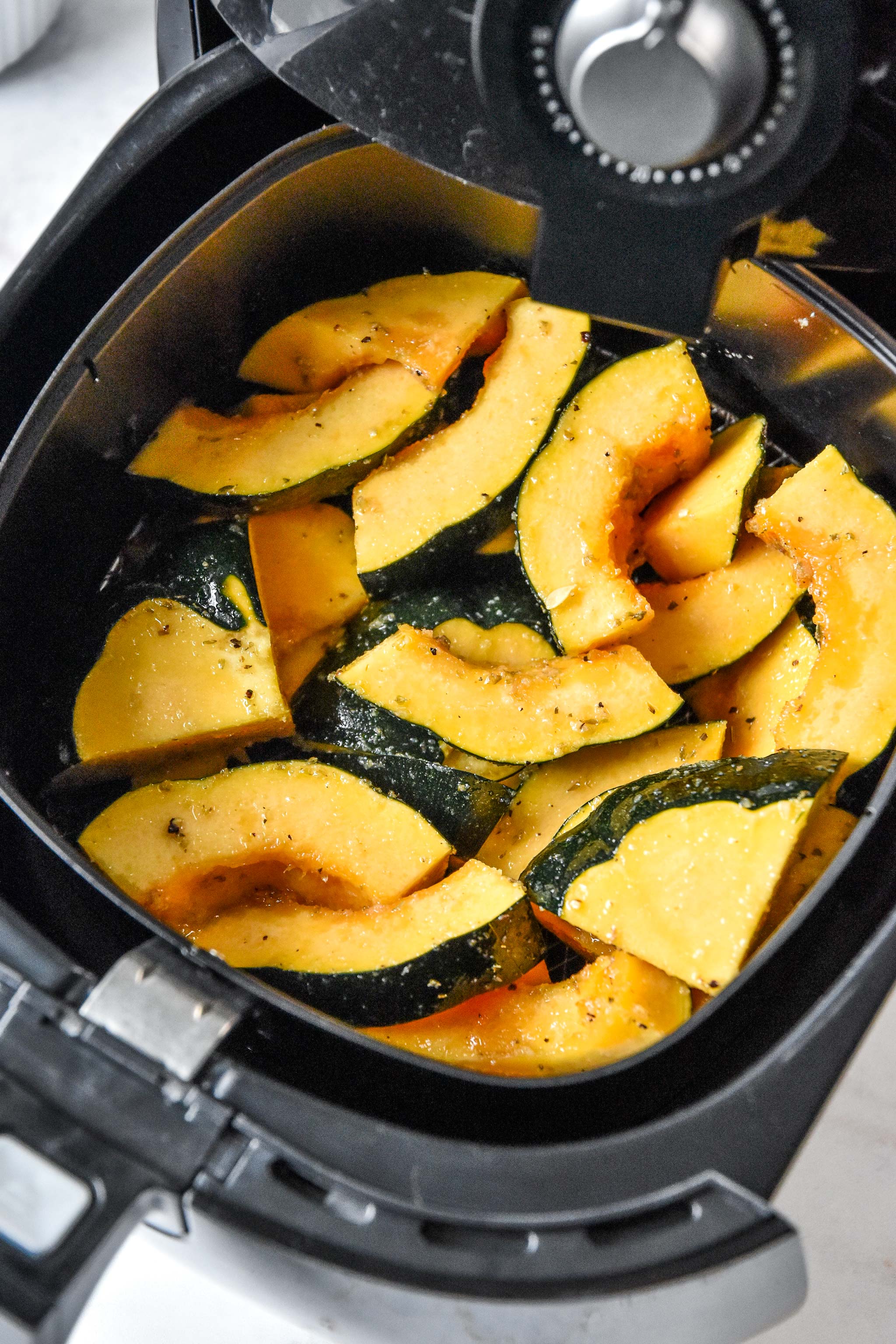 acorn squash in the air fryer ready to be cooked