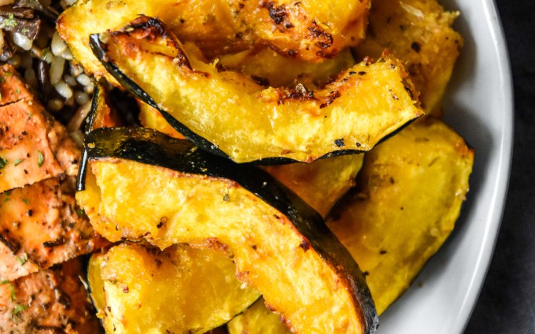 air fryer acorn squash on a plate with rice and chicken