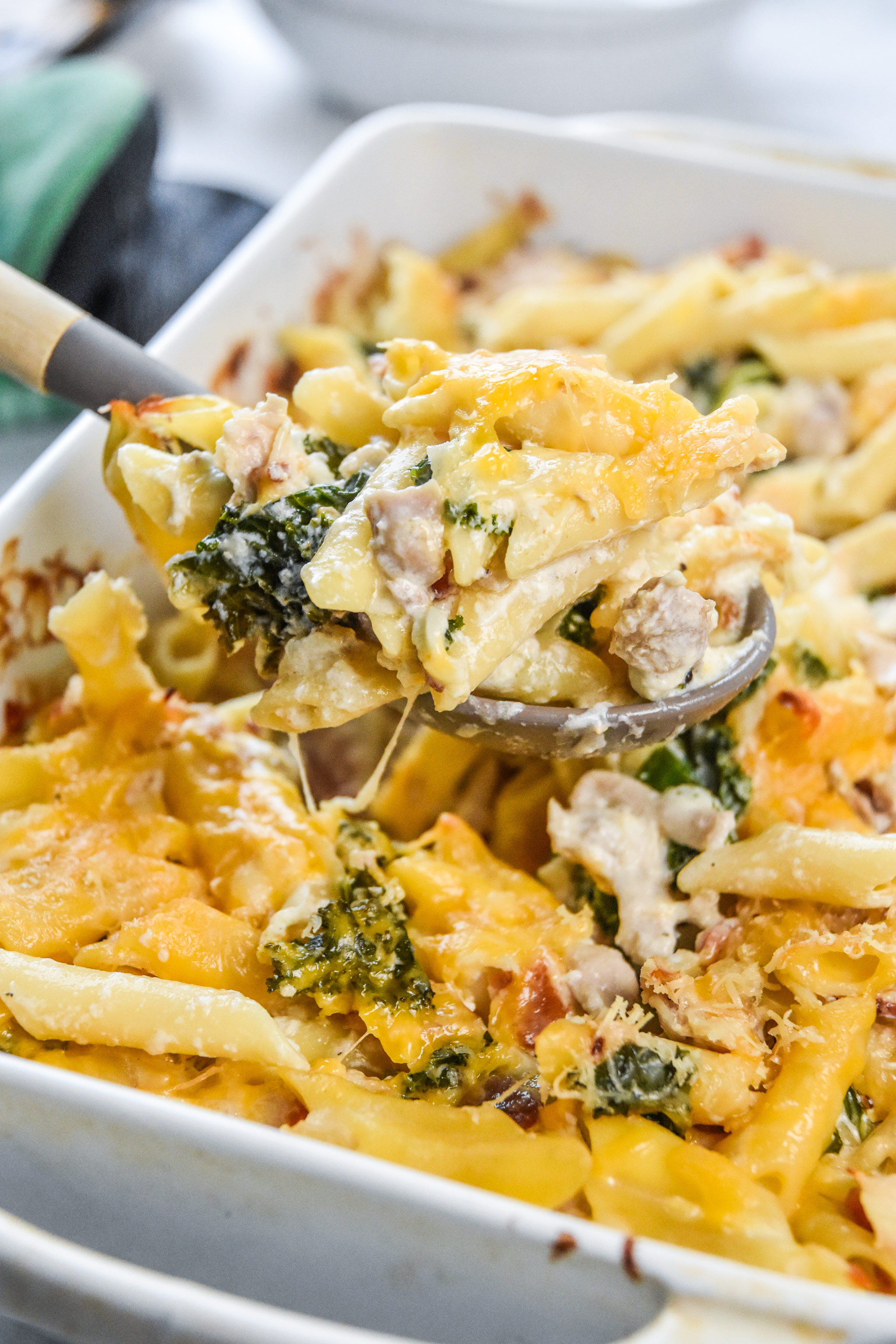 a scoop of fresh made cheesy chicken bacon ranch kale casserole