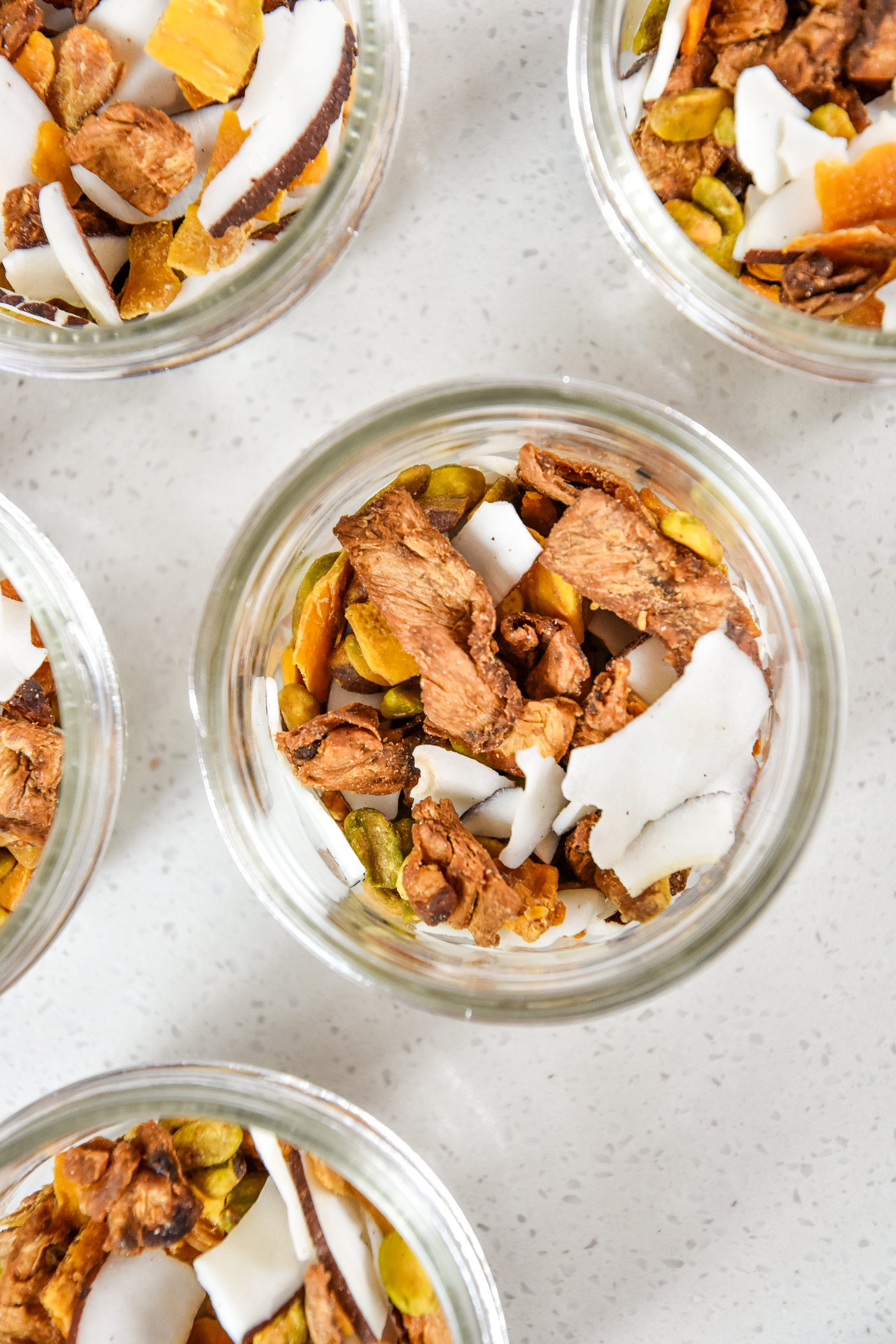 tropical dried fruit trail mix portioned into mason jars for snacks