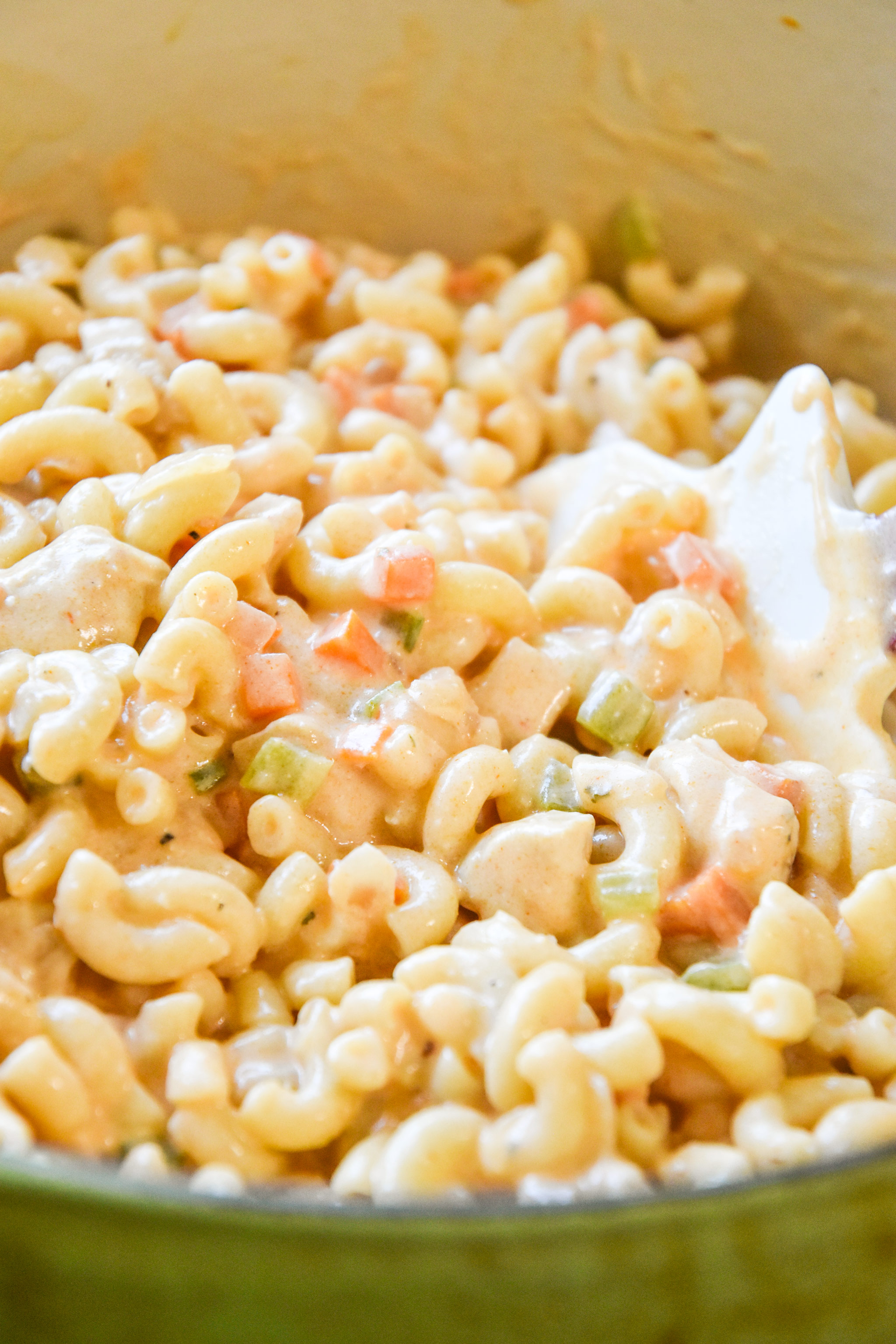 macaroni, veggies and sauce all mixed together to make buffalo chicken mac and cheese