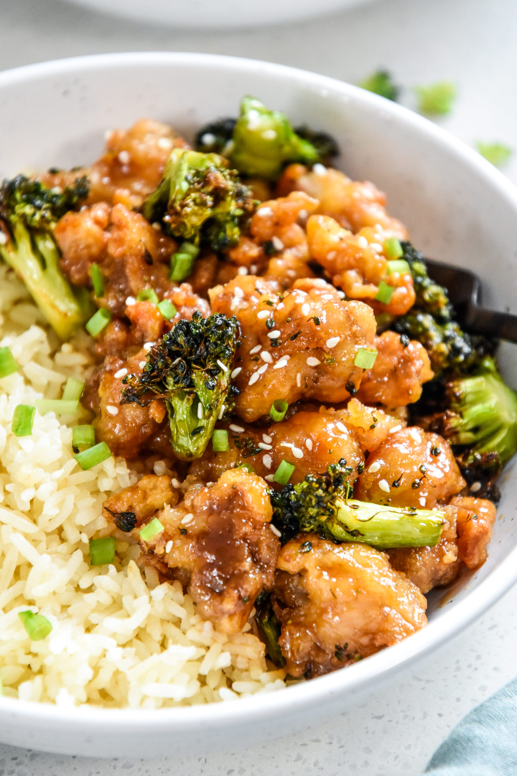 air fryer trader joes orange chicken and broccoli close up with a fork