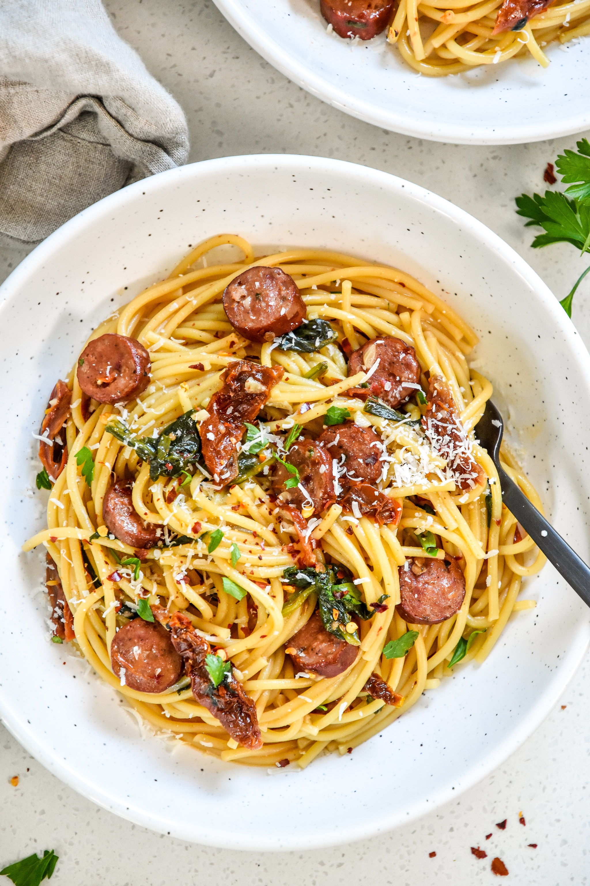 one pot italian sausage pasta in a bowl with fresh parm on top