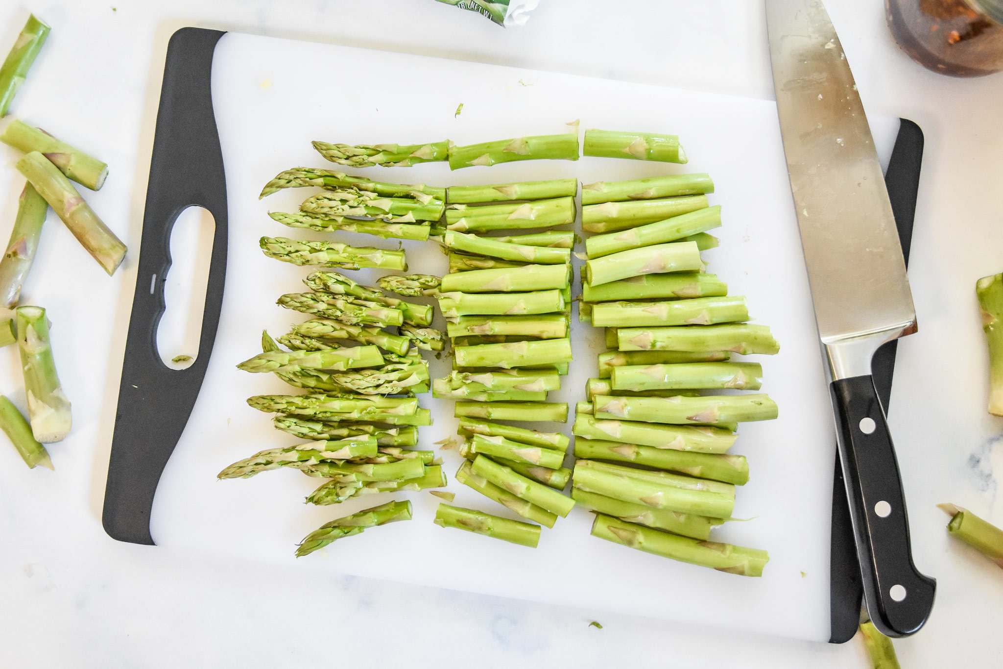 asparagus cut into thirds on a cutting board