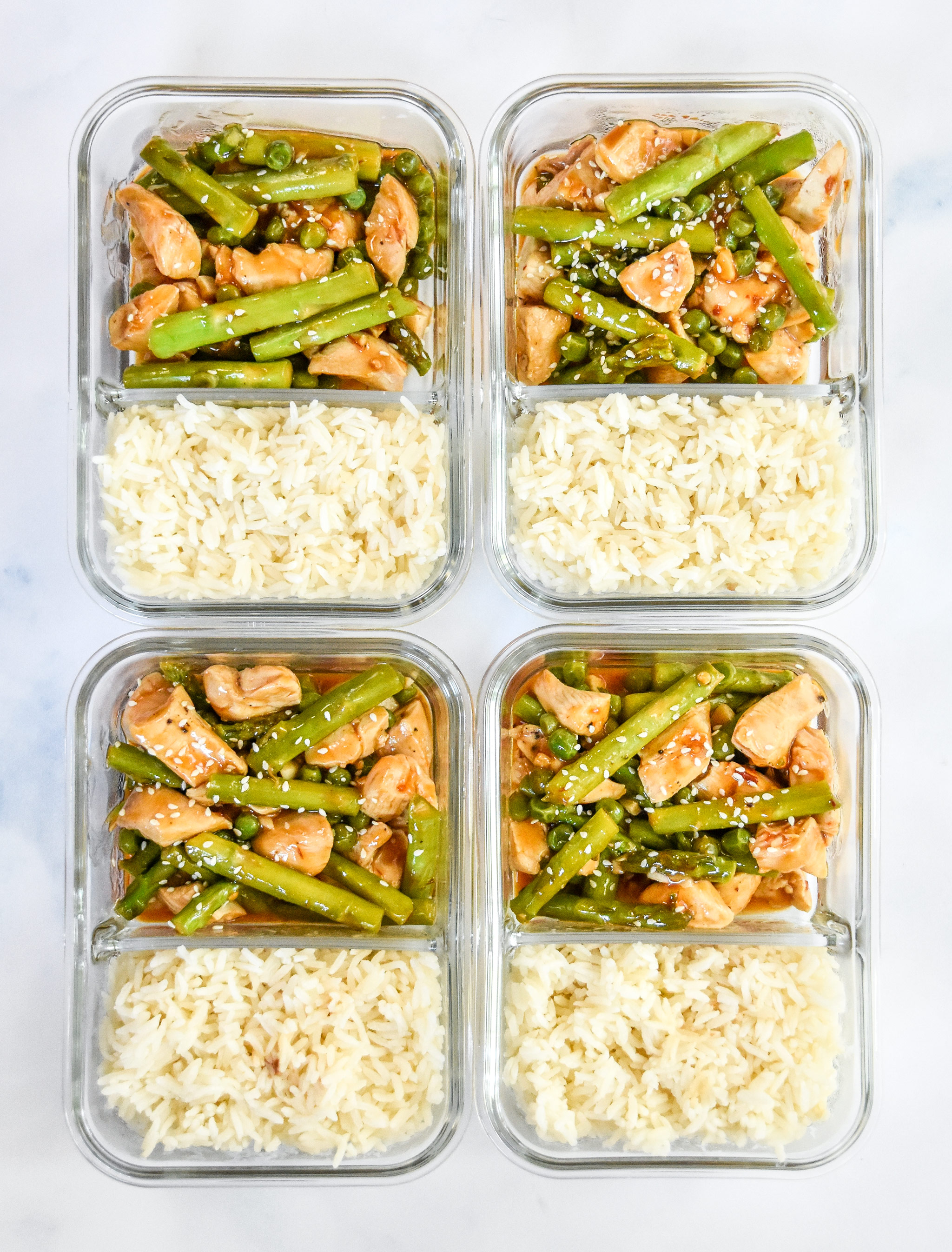 meal prep spicy chicken and asparagus in meal prep containers