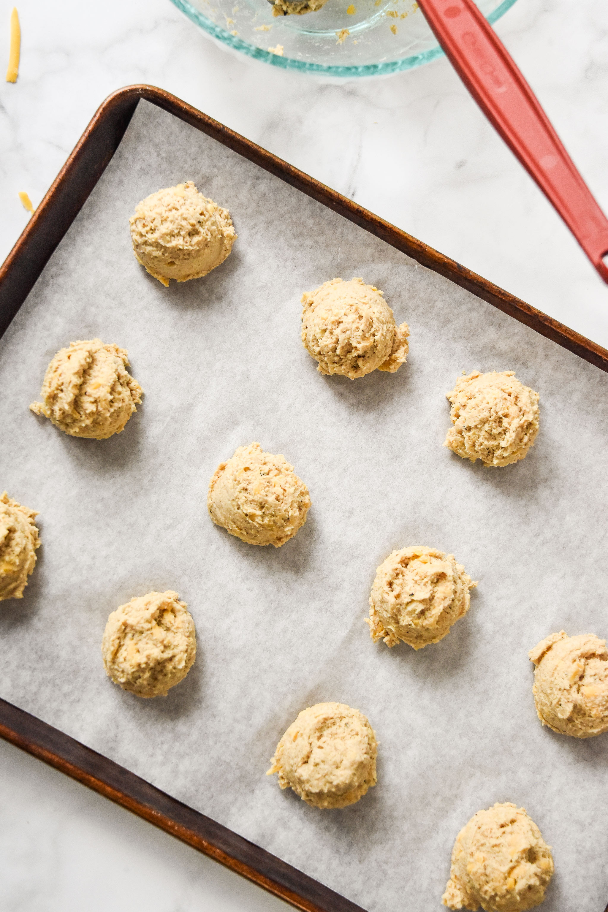 drop biscuit batter on a sheet pan with parchment paper.