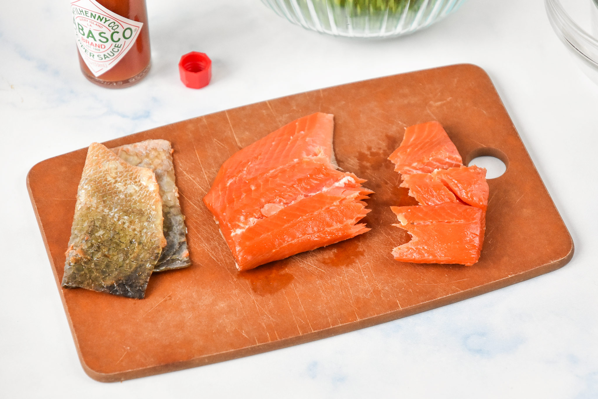 smoked salmon out of the package on a cutting board with the skin removed.