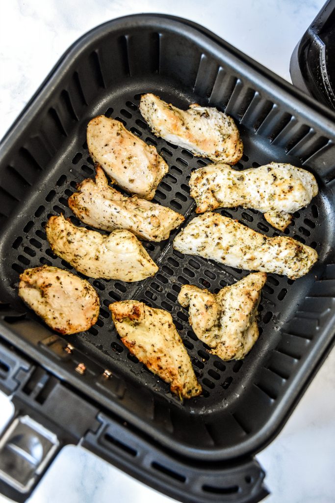 cooked air fryer chicken tenders in the air fryer basket.