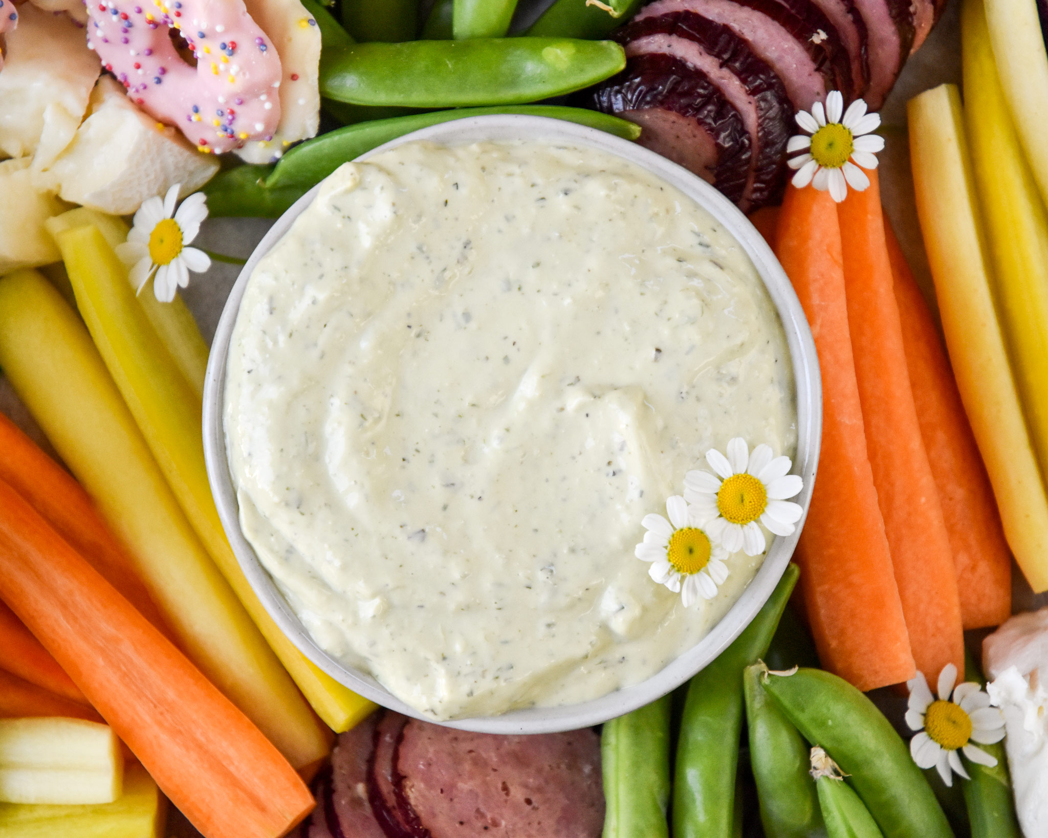 close up of the green goddess dip on the snack platter in a bowl.