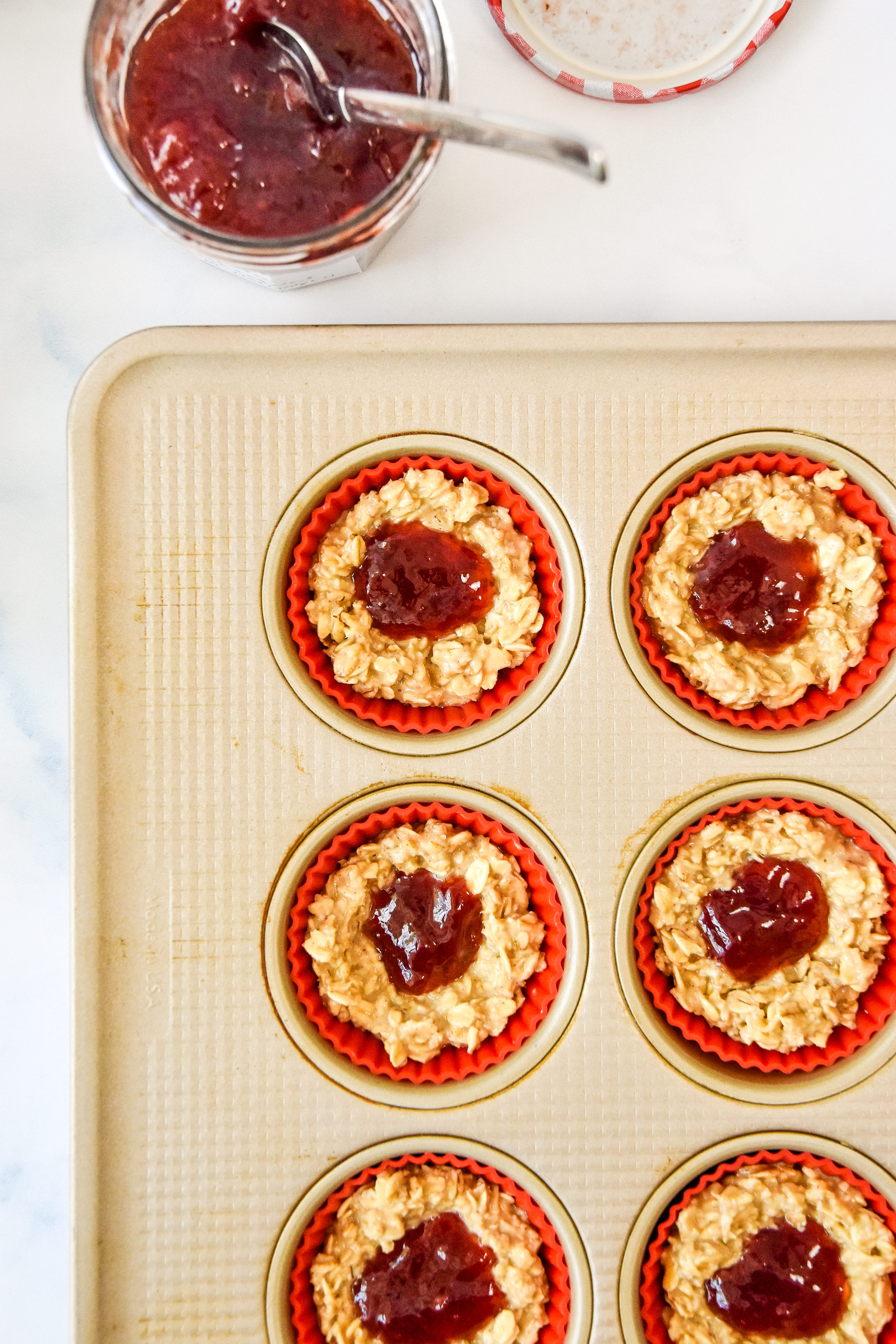 jelly in the center of each oatmeal cup in the muffin tin.