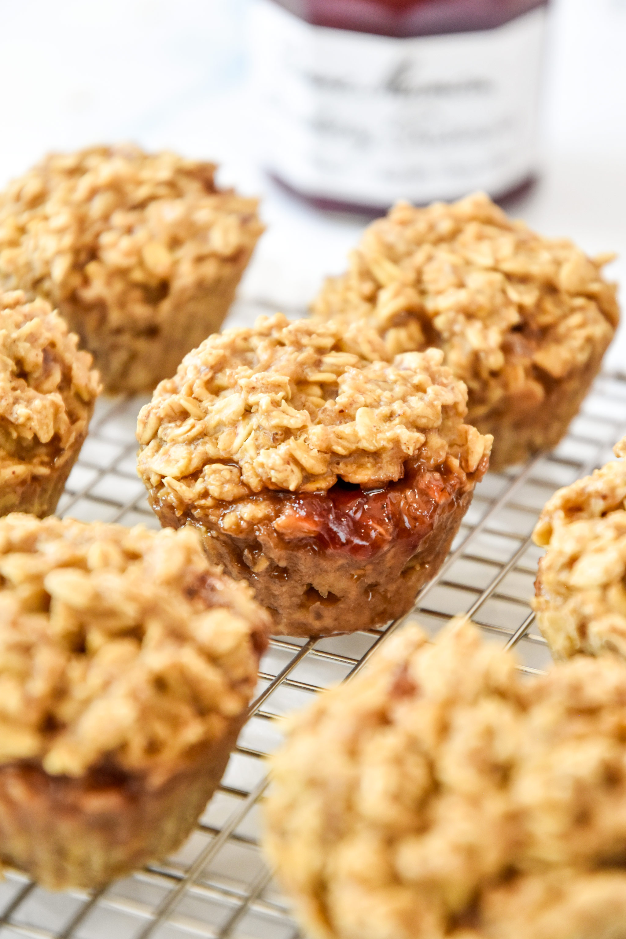peanut butter & jelly baked oatmeal cups on a cooling rack.