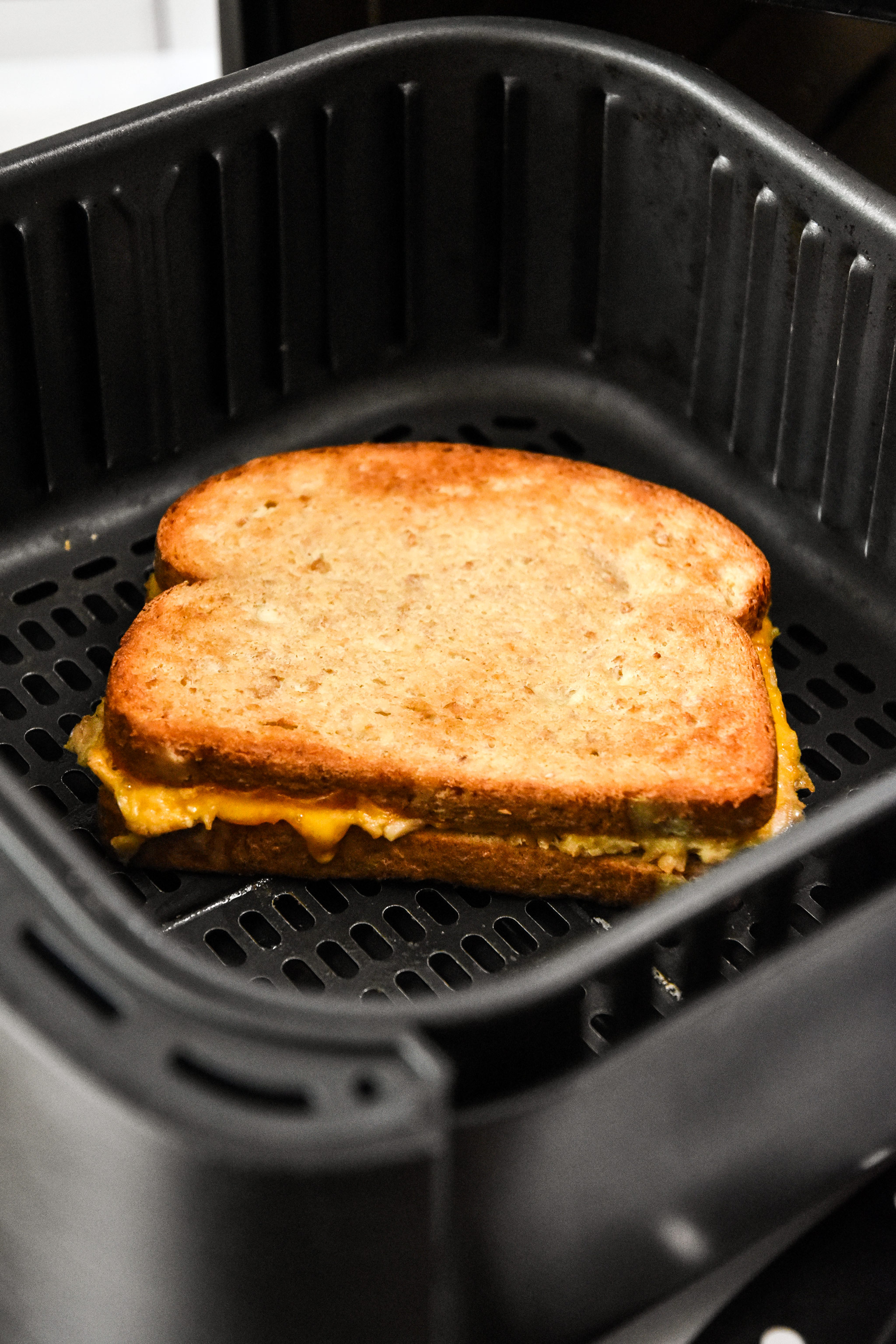 cooked air fryer tuna melt in the air fryer basket.