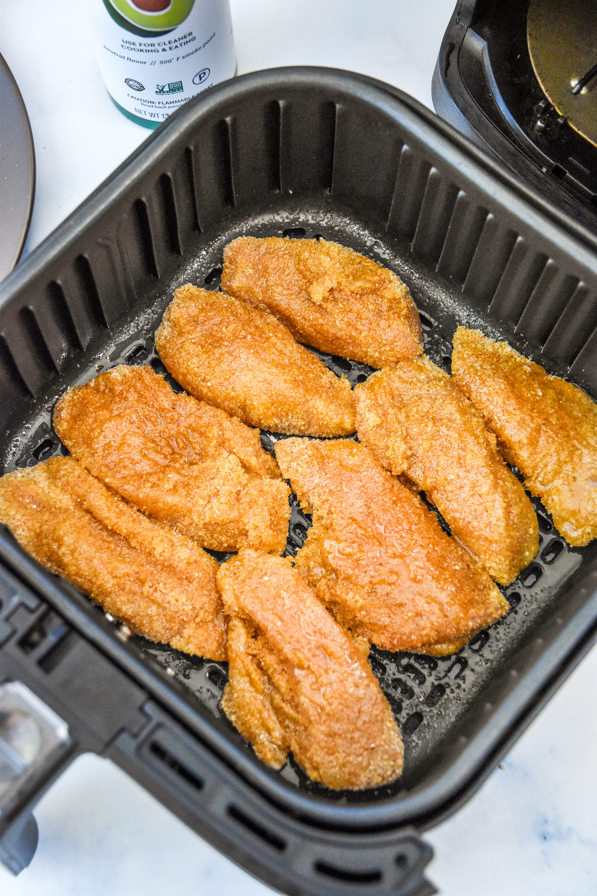 the chicken tenders after spraying with avocado oil spray.