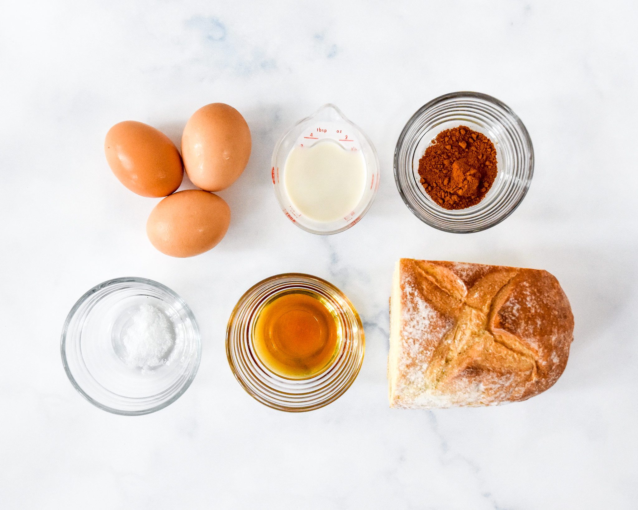 ingredients on a table to make the air fryer french toast bites including bread and eggs.