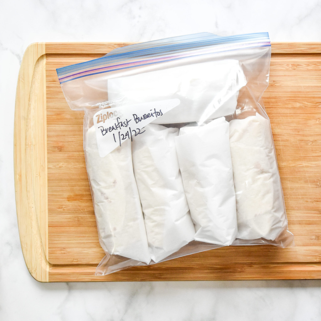 freezer friendly breakfast burritos in a ziploc freezer bag with label.