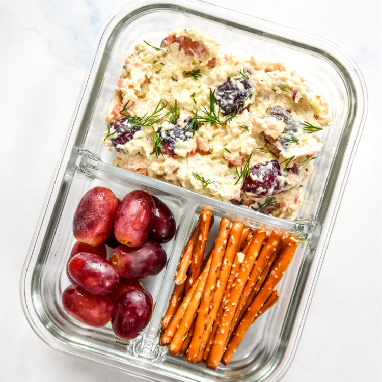 glass meal prep container with easy chicken salad with grapes and pretzels.