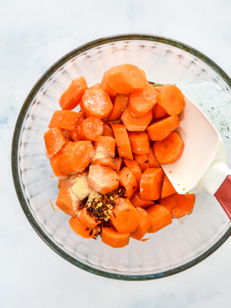 mixing up the carrots and spice to make hot honey glazed carrots.