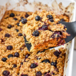 serving a portion of easy blueberry lemon baked oatmeal on a spatula.
