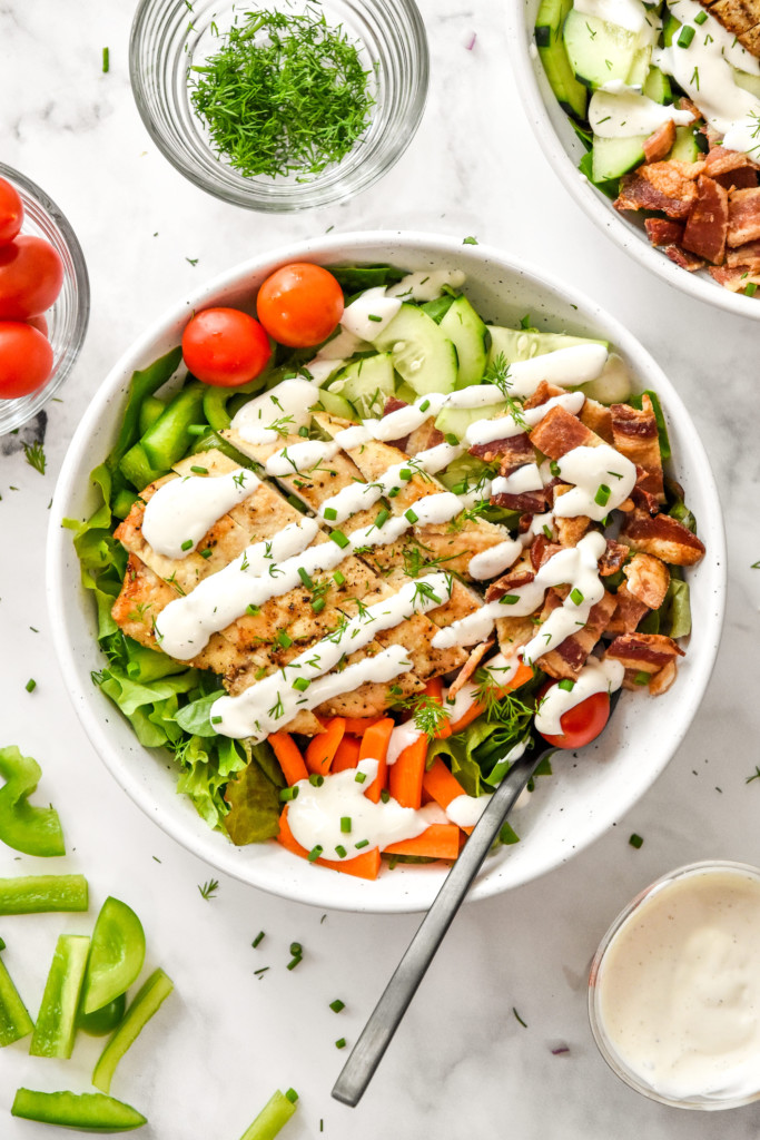 go-to chicken bacon ranch salad with fresh herbs in a white dinner bowl.