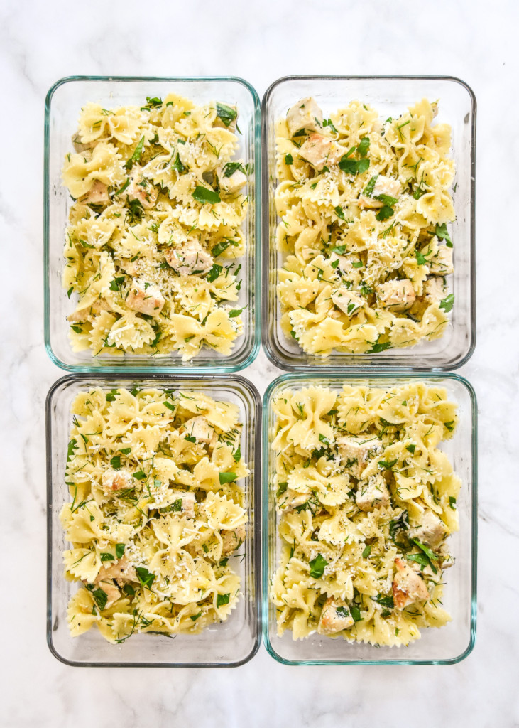 herby lemon chicken pasta salad in glass meal prep containers.