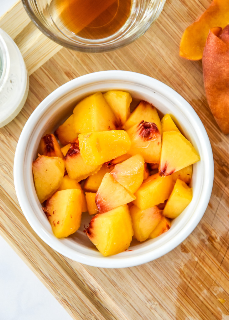 cut peaches in a bowl before cooking.