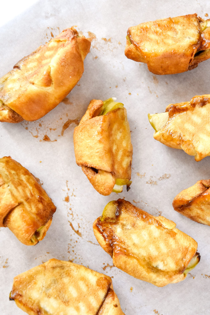 cooling the air fryer apple pie crescent rolls on their sides.