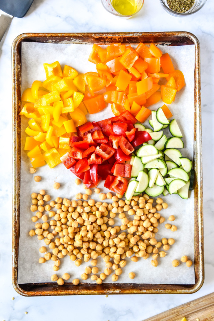 bell peppers zucchini and chickpeas on a sheet pan.