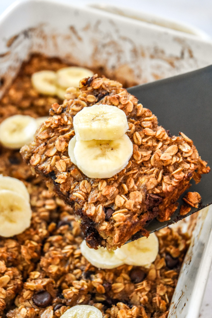 a slice of chocolate chip banana bread baked oatmeal with fresh bananas on top.
